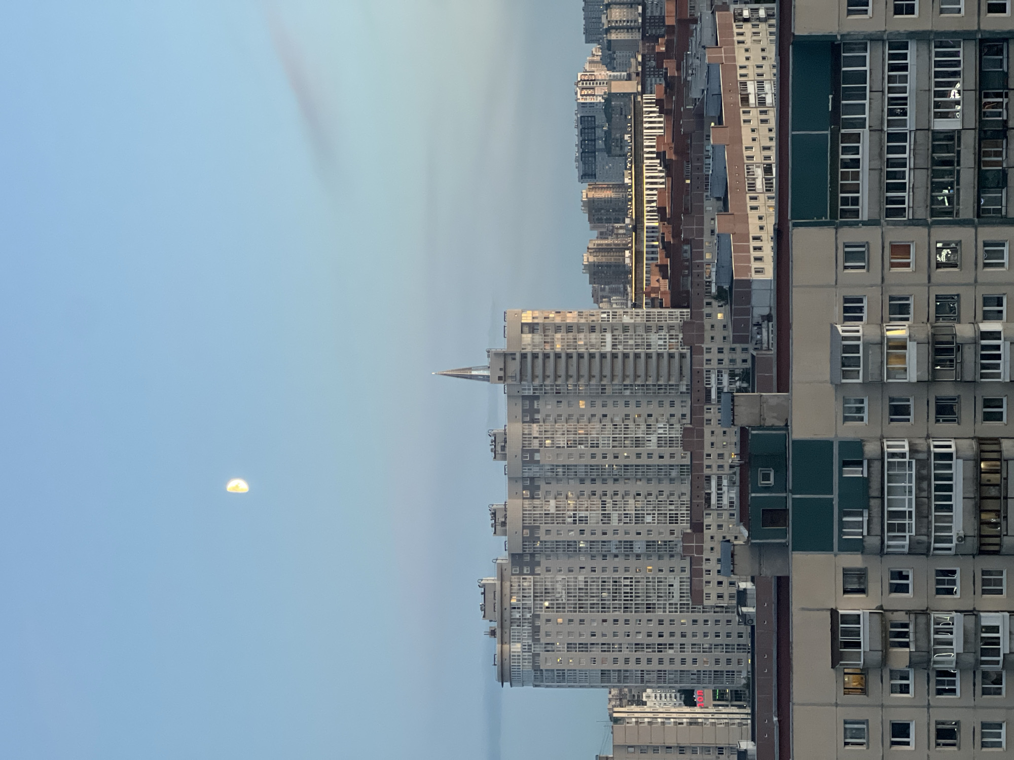 Crescent moon over beige apartment blocks in Saint Petersburg