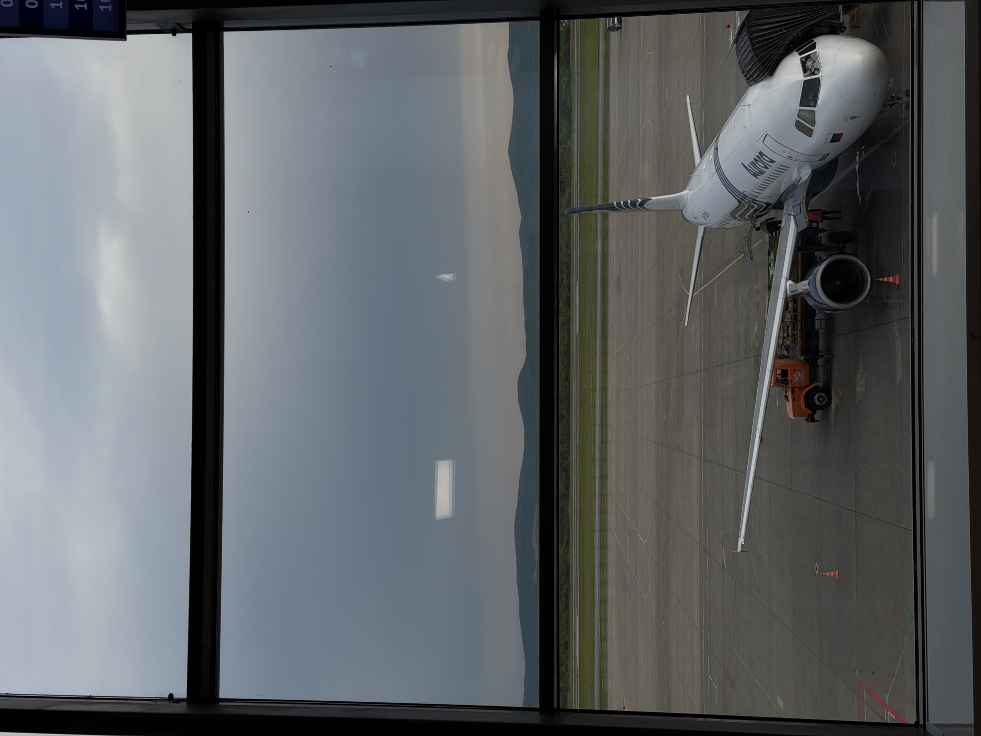 Traveler waits as Aurora aircraft services at Artyom Airport