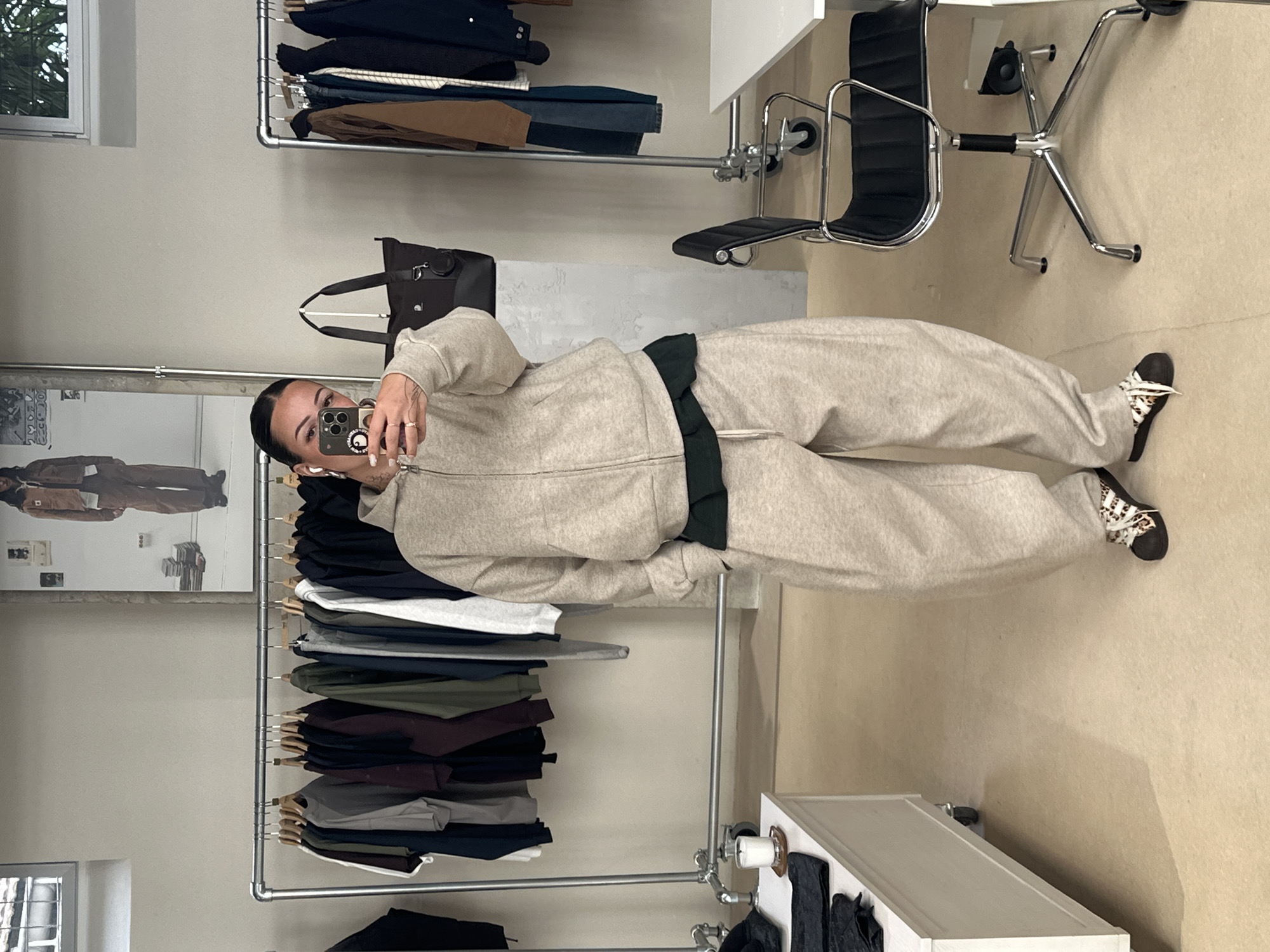 Customer takes mirror selfies in Paris clothing store