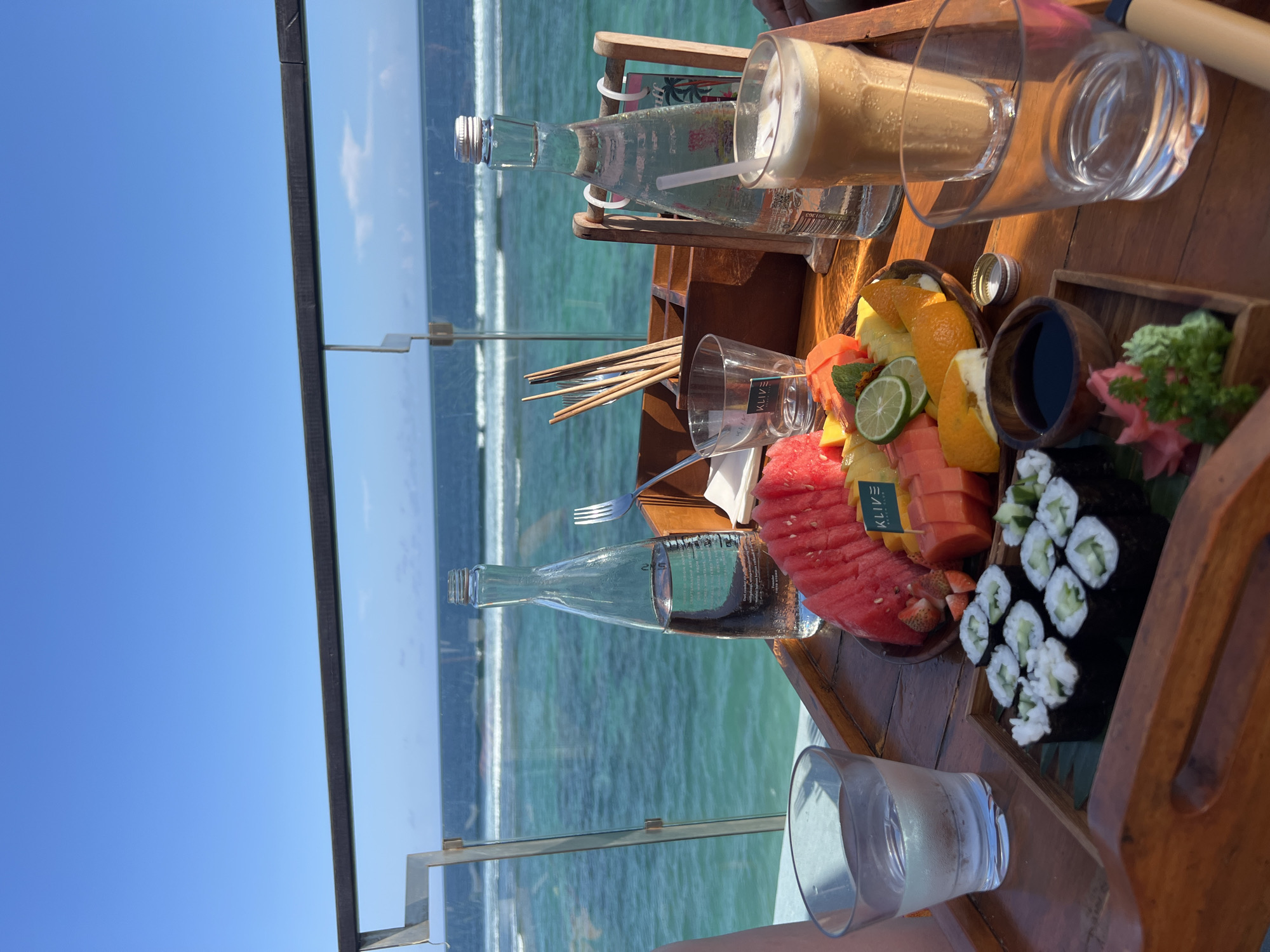 Beachside lounge area observed overlooking turquoise coastal waters