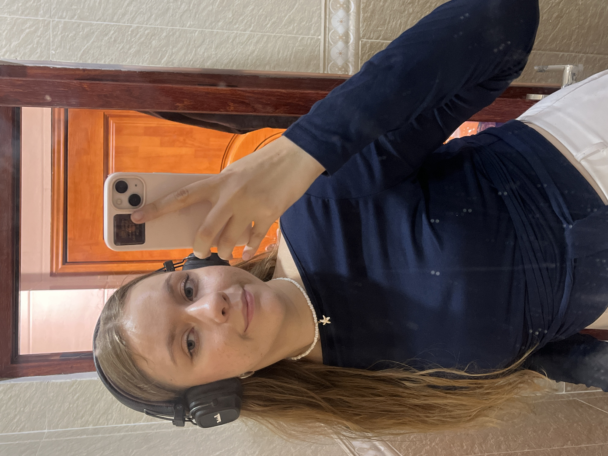 Young woman takes bathroom selfies in Thuận An, Vietnam