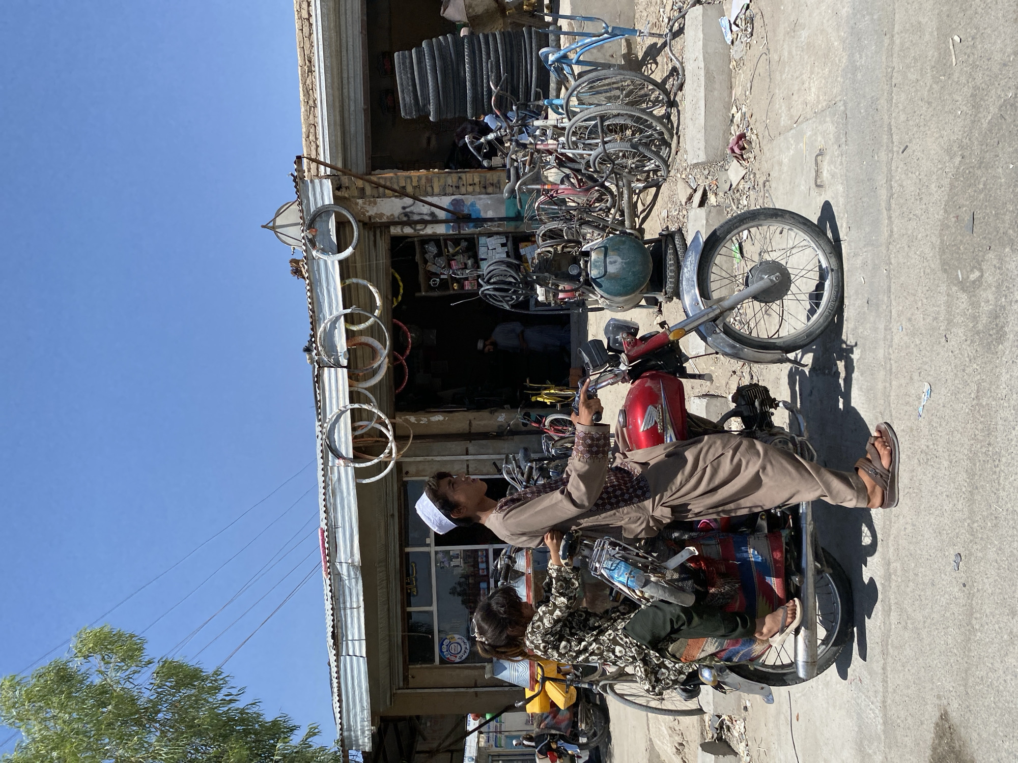 Morning street scenes on motorcycle and bicycle in Kandahar