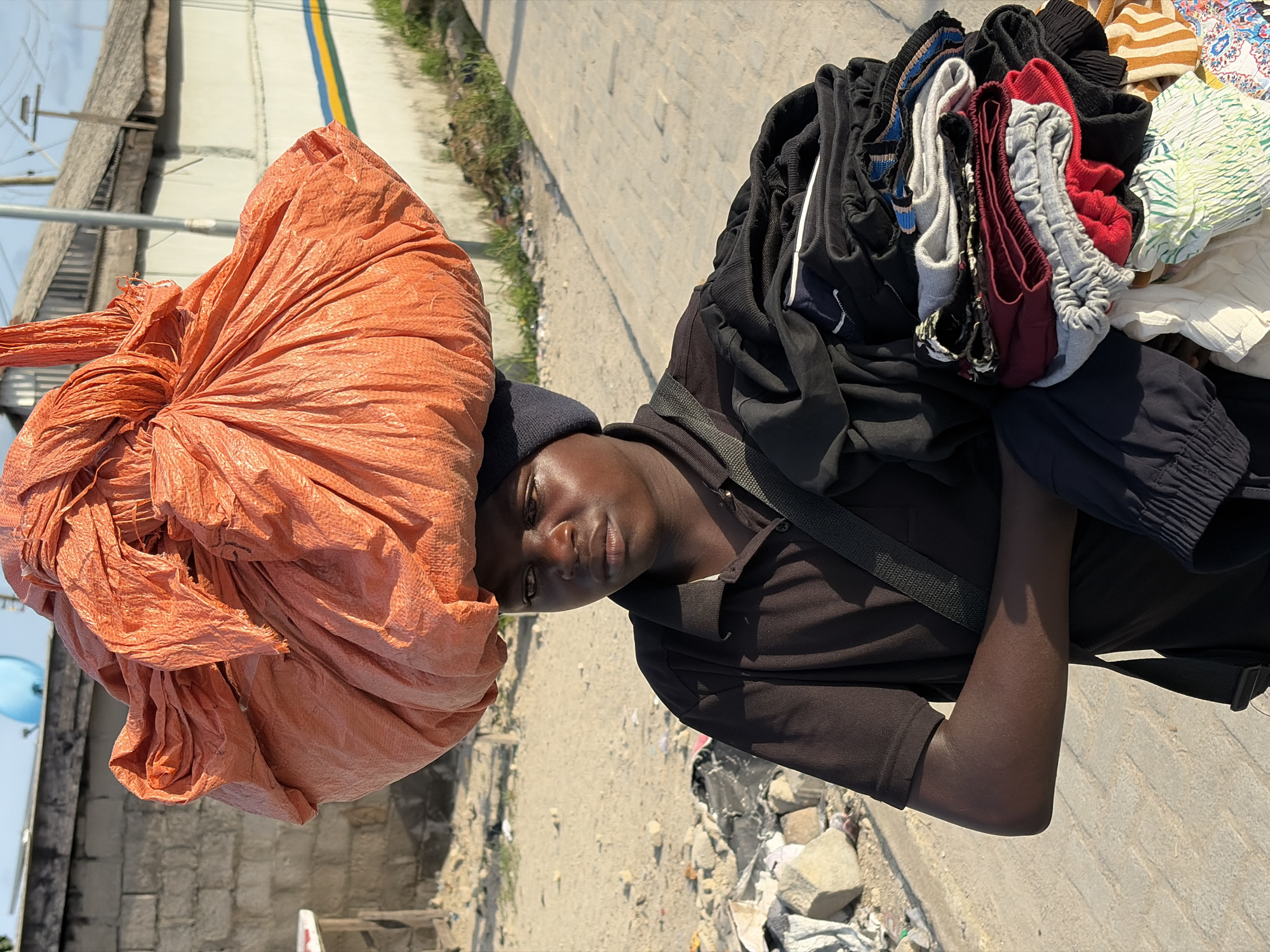 Residents carry belongings through Igboefon, Nigeria