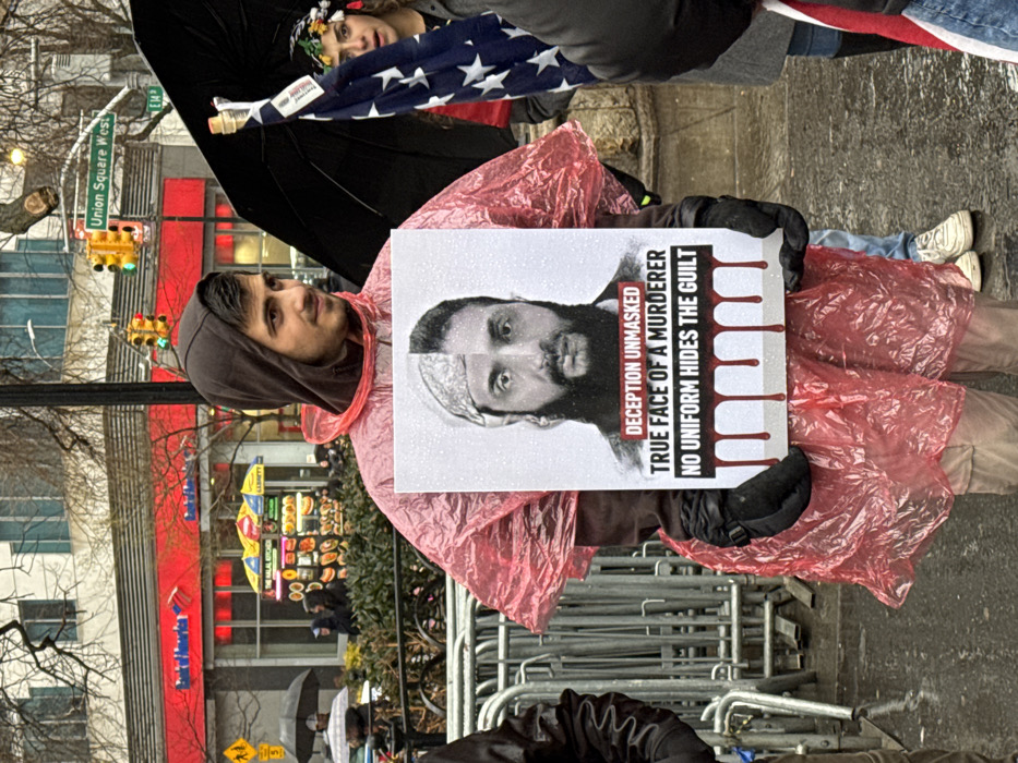 Protesters gather in wet New York square with signs