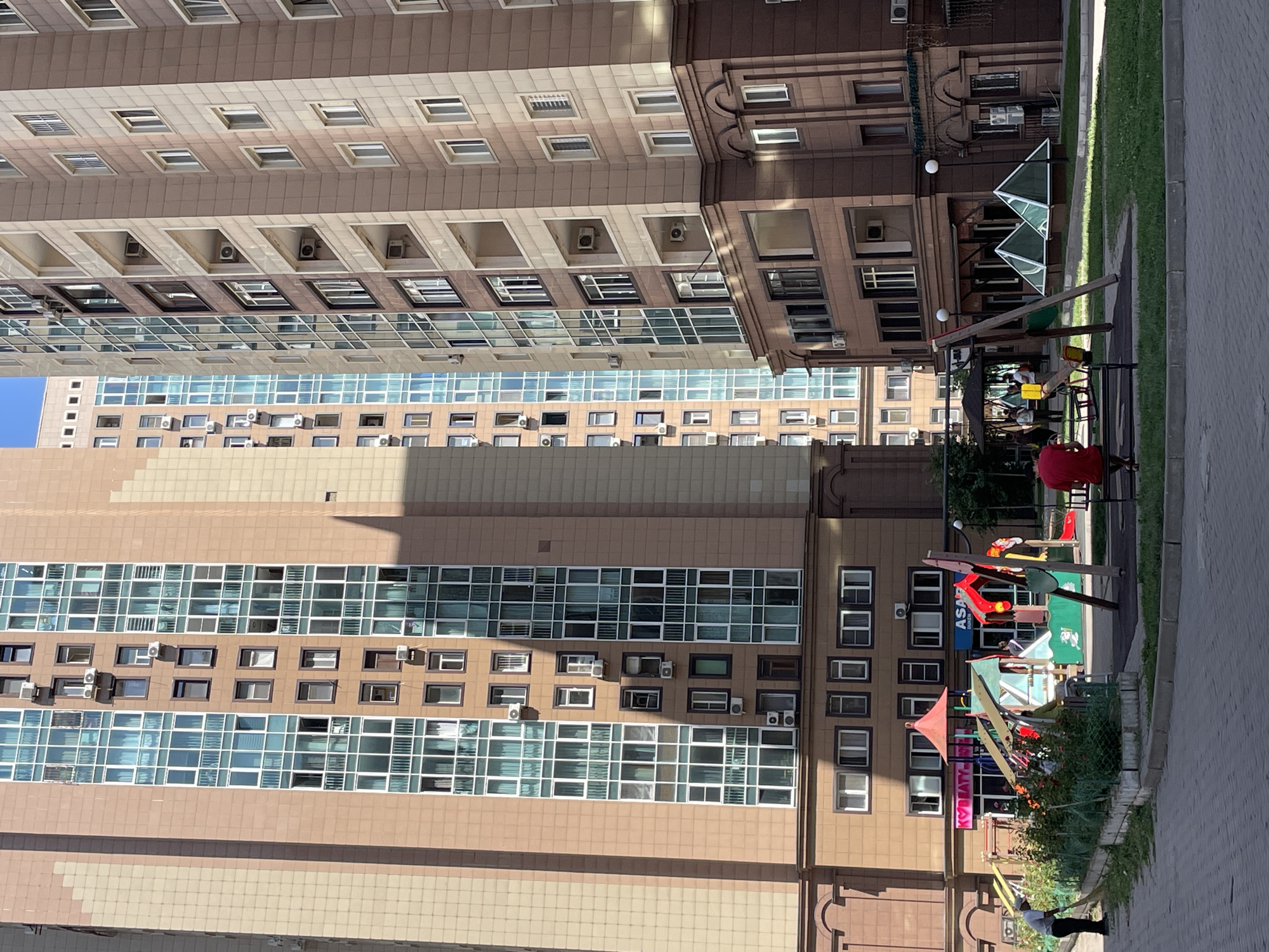 Everyday life in an Almaty residential neighborhood on a sunny morning