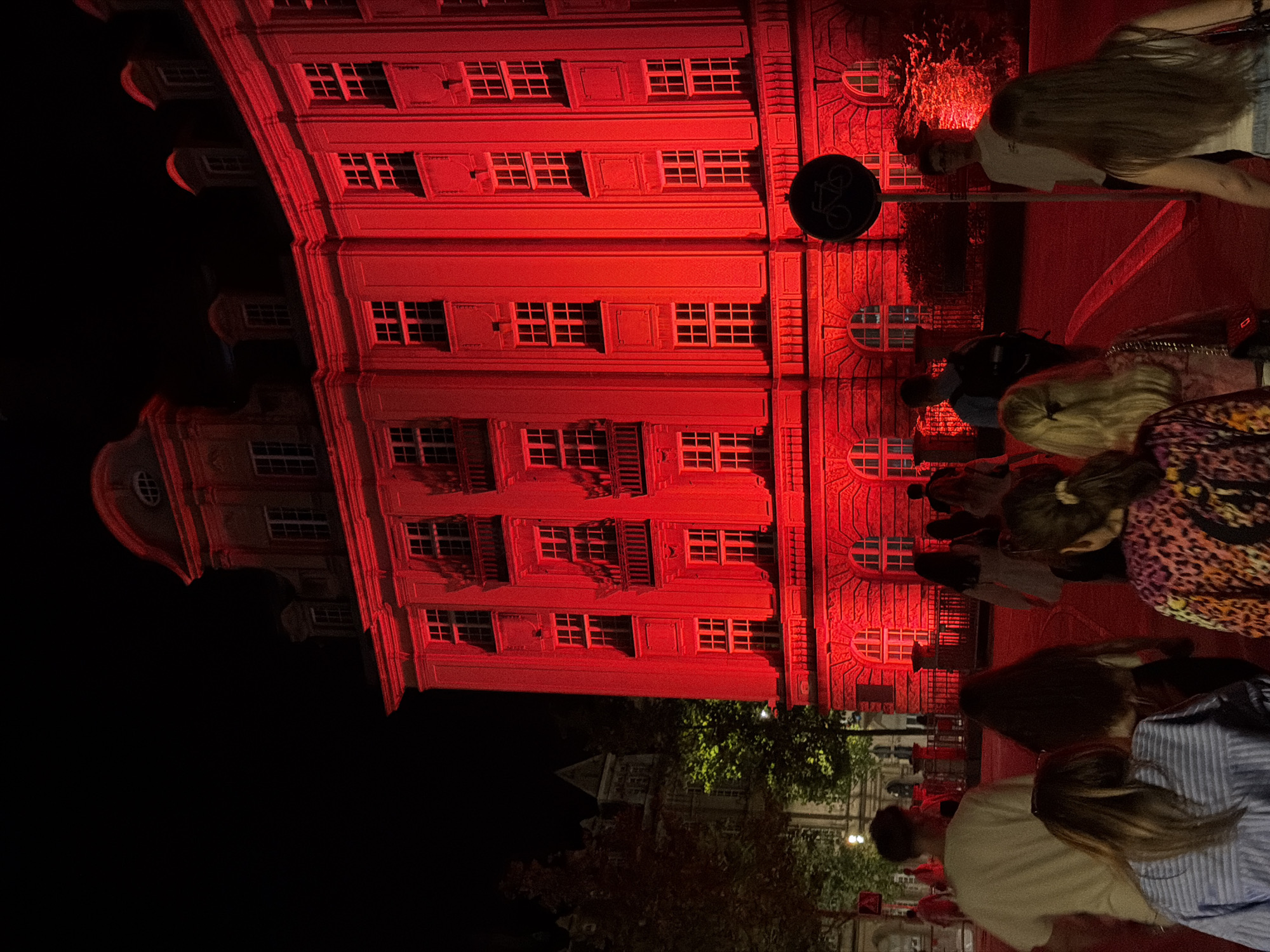 Historic Luxembourg building glows red on a summer night
