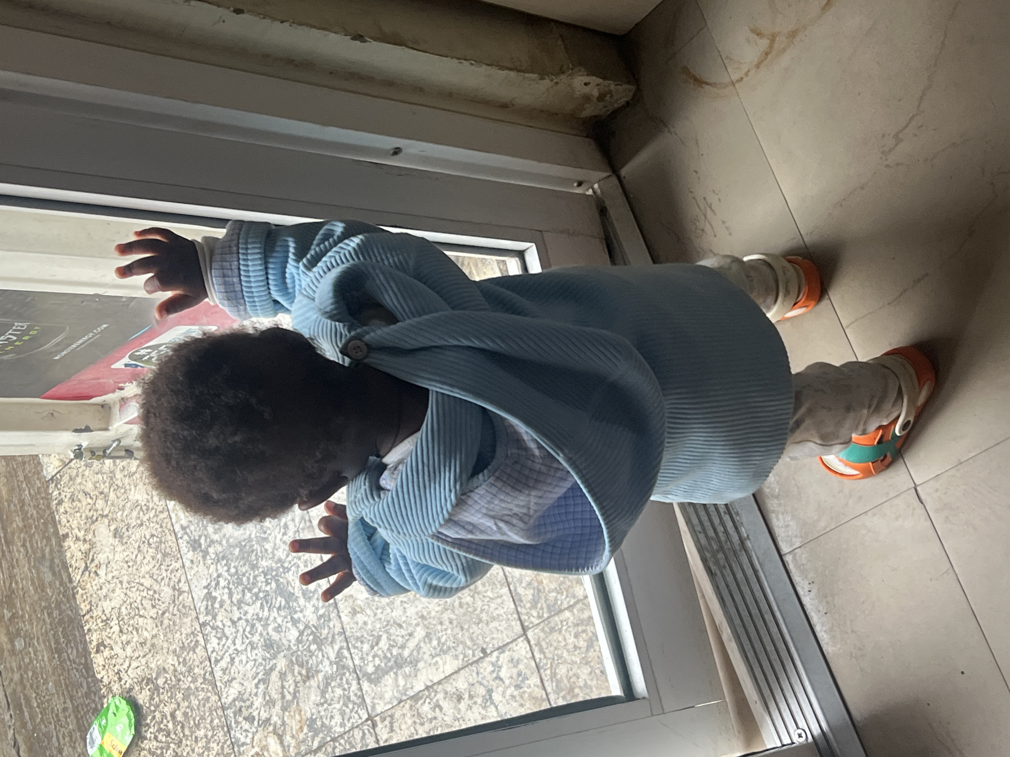 Child plays indoors in Gura Top, Nigeria morning session