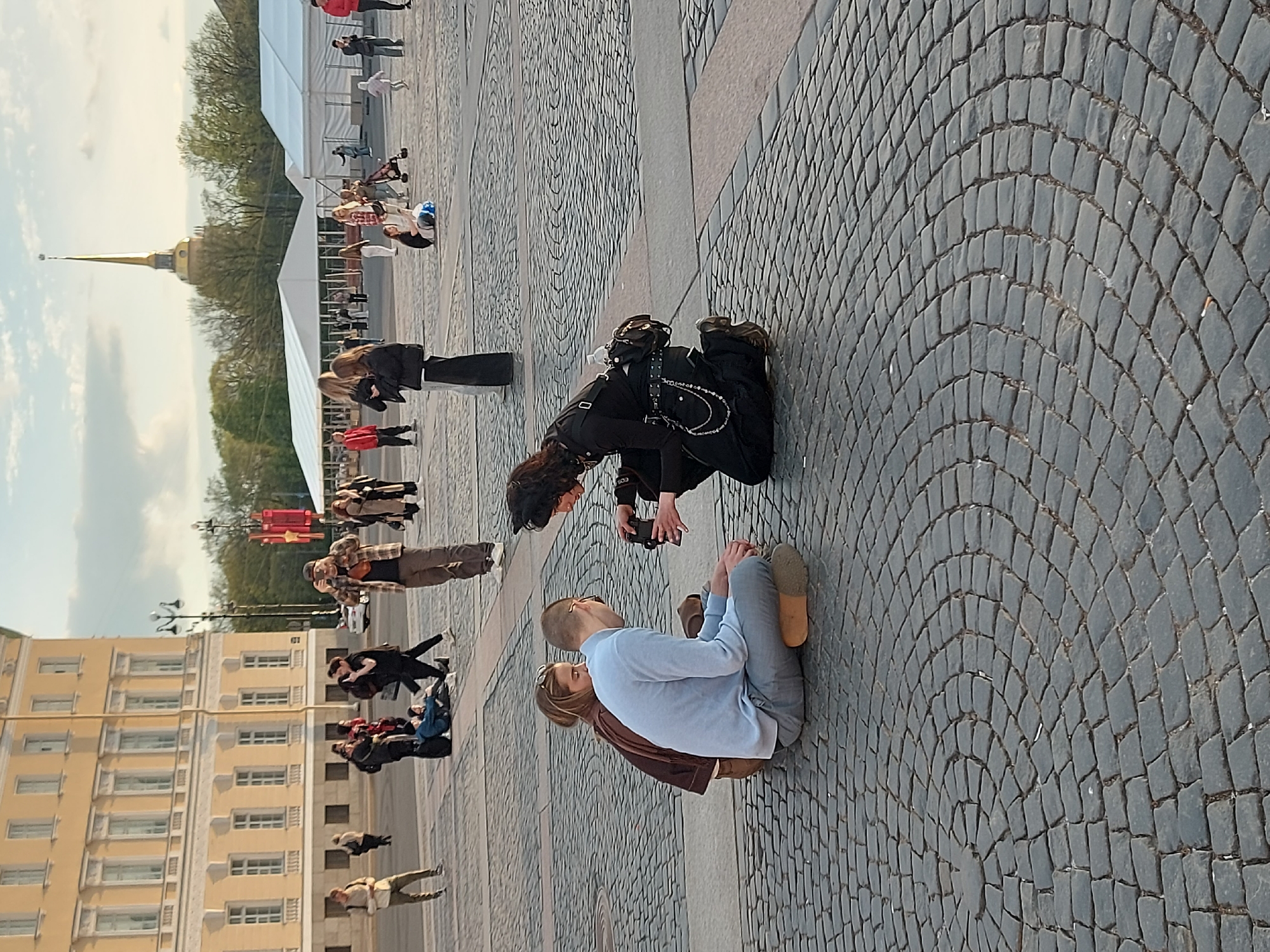 Street performer, couples gather in Saint Petersburg's Palace Square