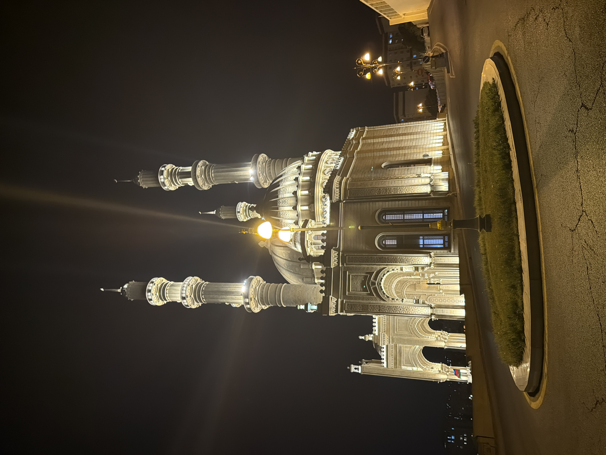 Baku night: mosque, wet streets, and a city bus