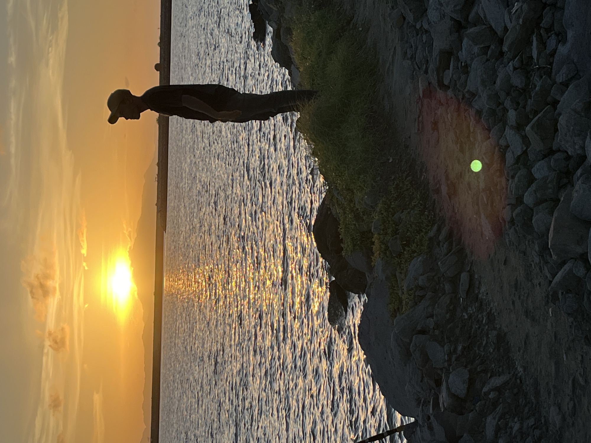 Fishing at sunset on Banda Aceh's rocky shoreline