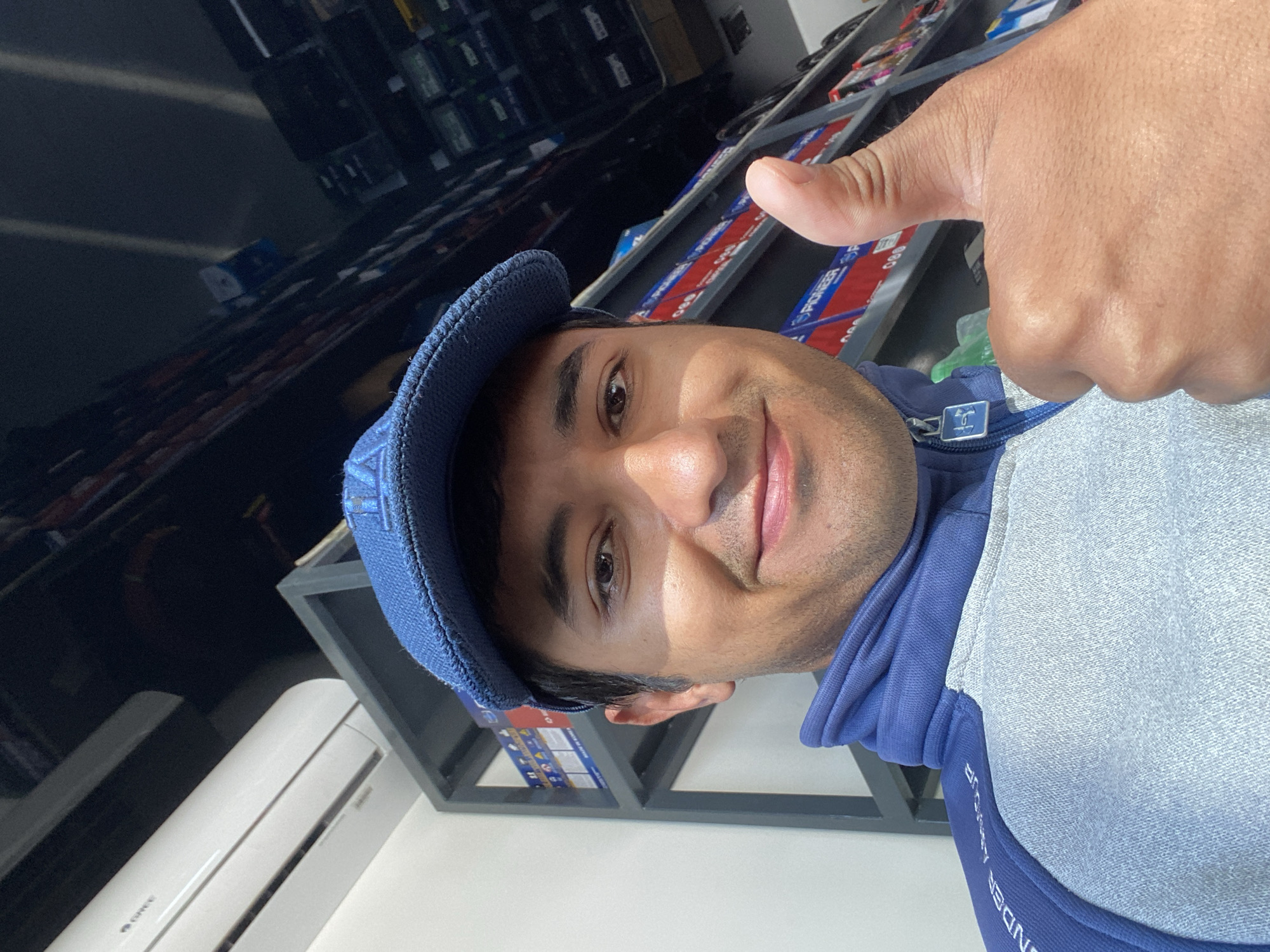 Customer poses with thumbs up at Bukhara auto parts store