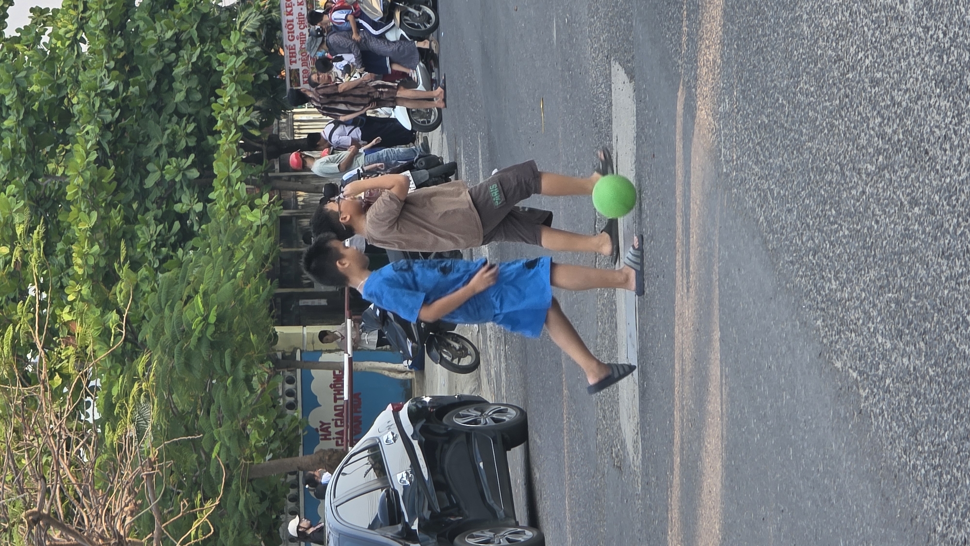 School children play with ball on Vietnam street