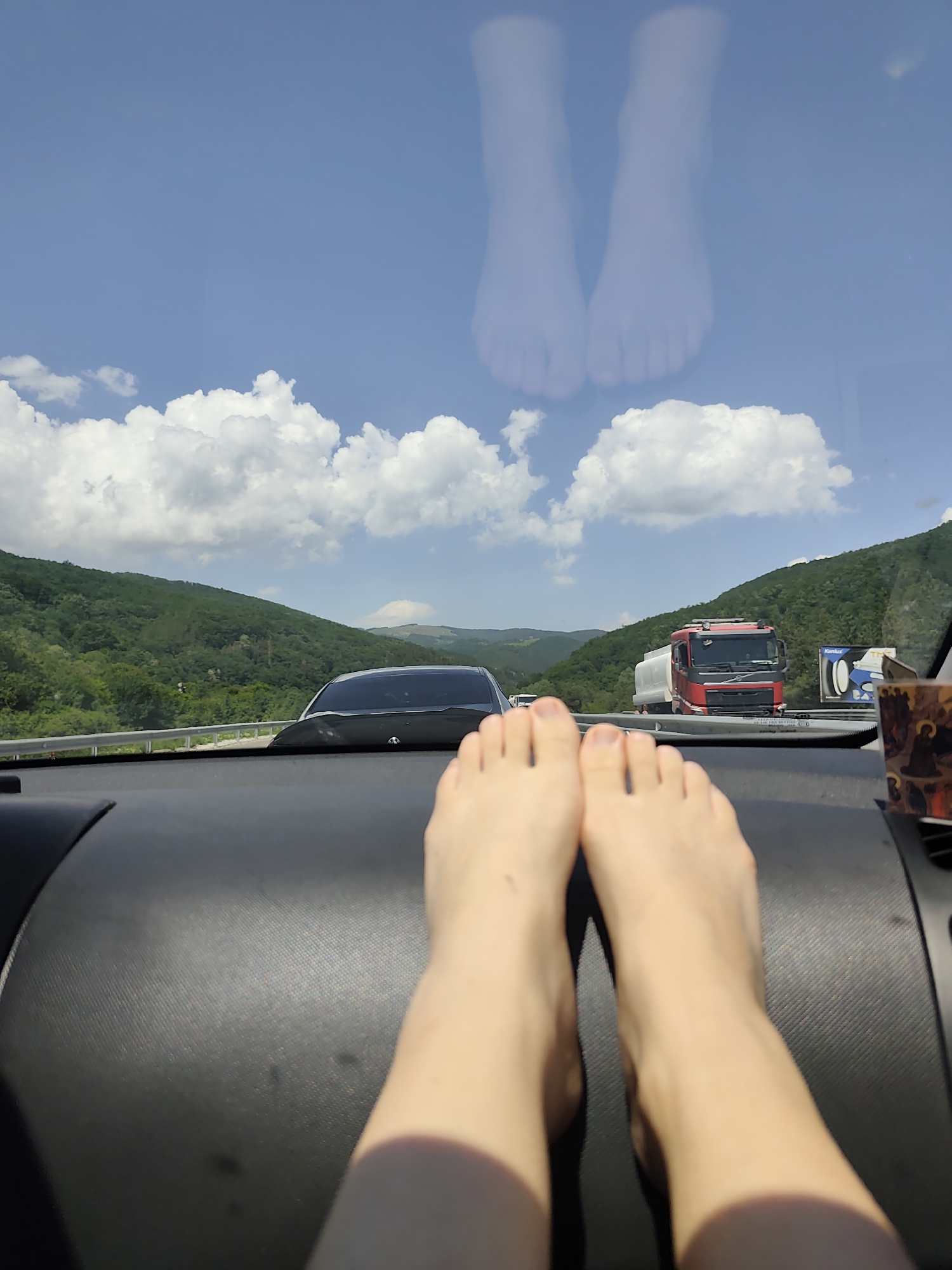 Highway journey through mountains captured from vehicle interior