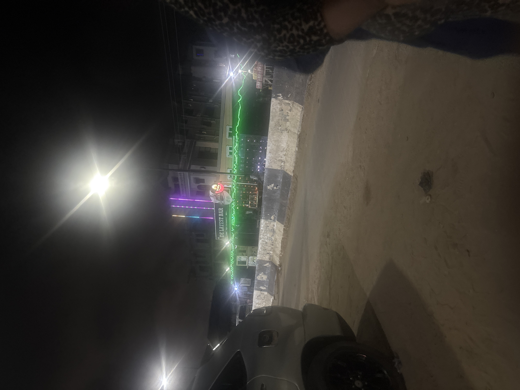 Colorful nighttime lighting observed at bar in Satellite Town