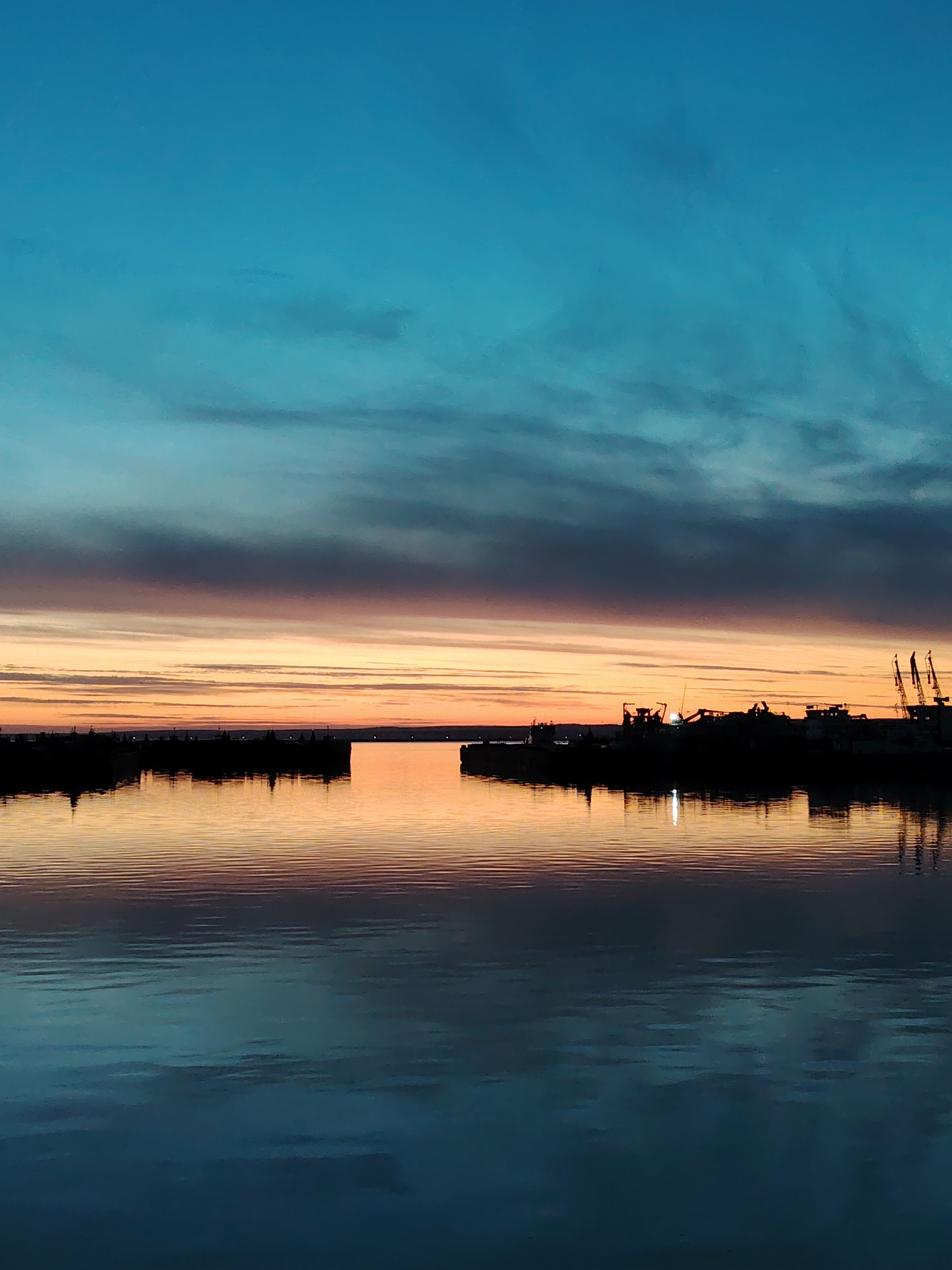 Evening bicycle journey documented along Chaikovsky waterfront during twilight hours