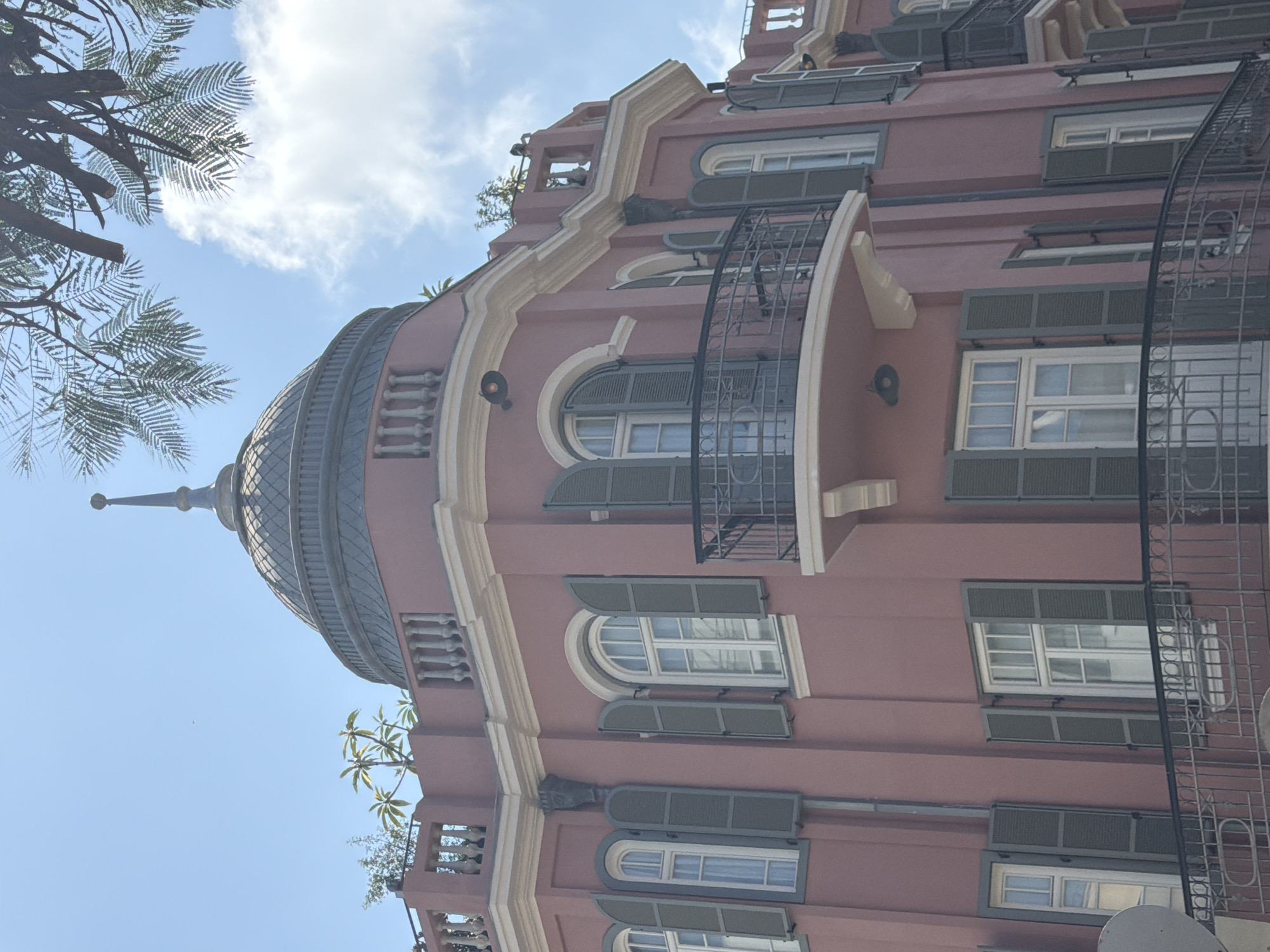 Street musician performs in Tel Aviv amid distinctive architecture