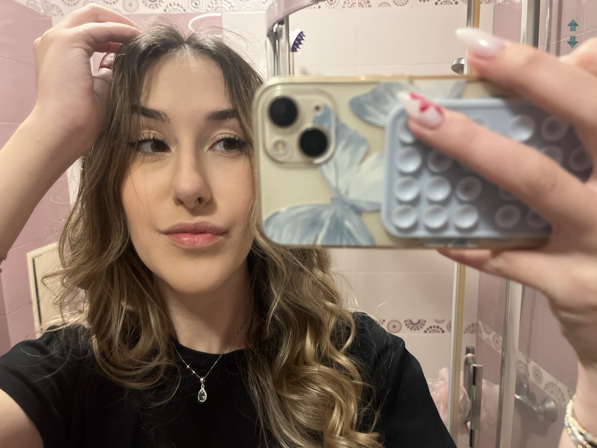 Woman takes selfies in pink bathroom in Sofia