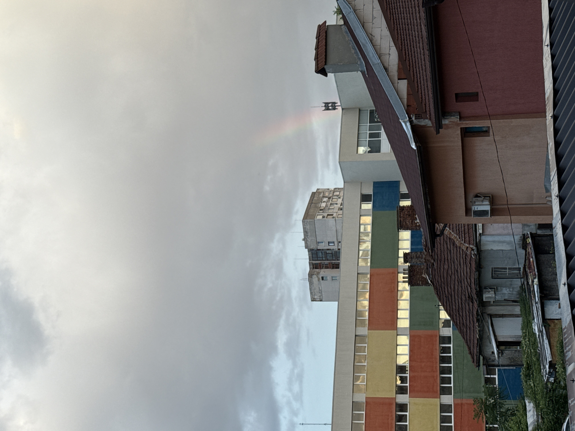 Faint rainbow over Sofia's rooftops on a cloudy evening