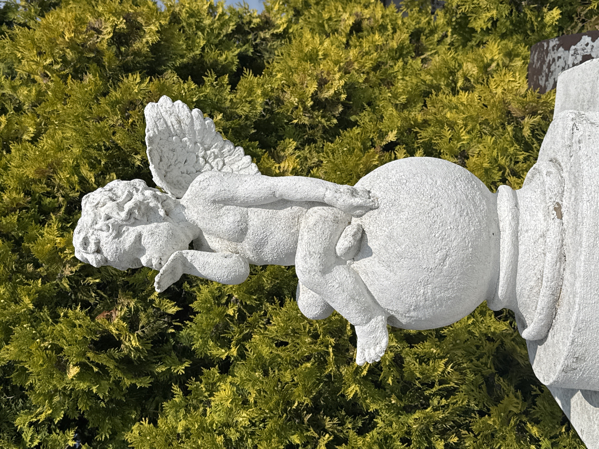 Cherub statue and decaying garage door in Bagrationovsk