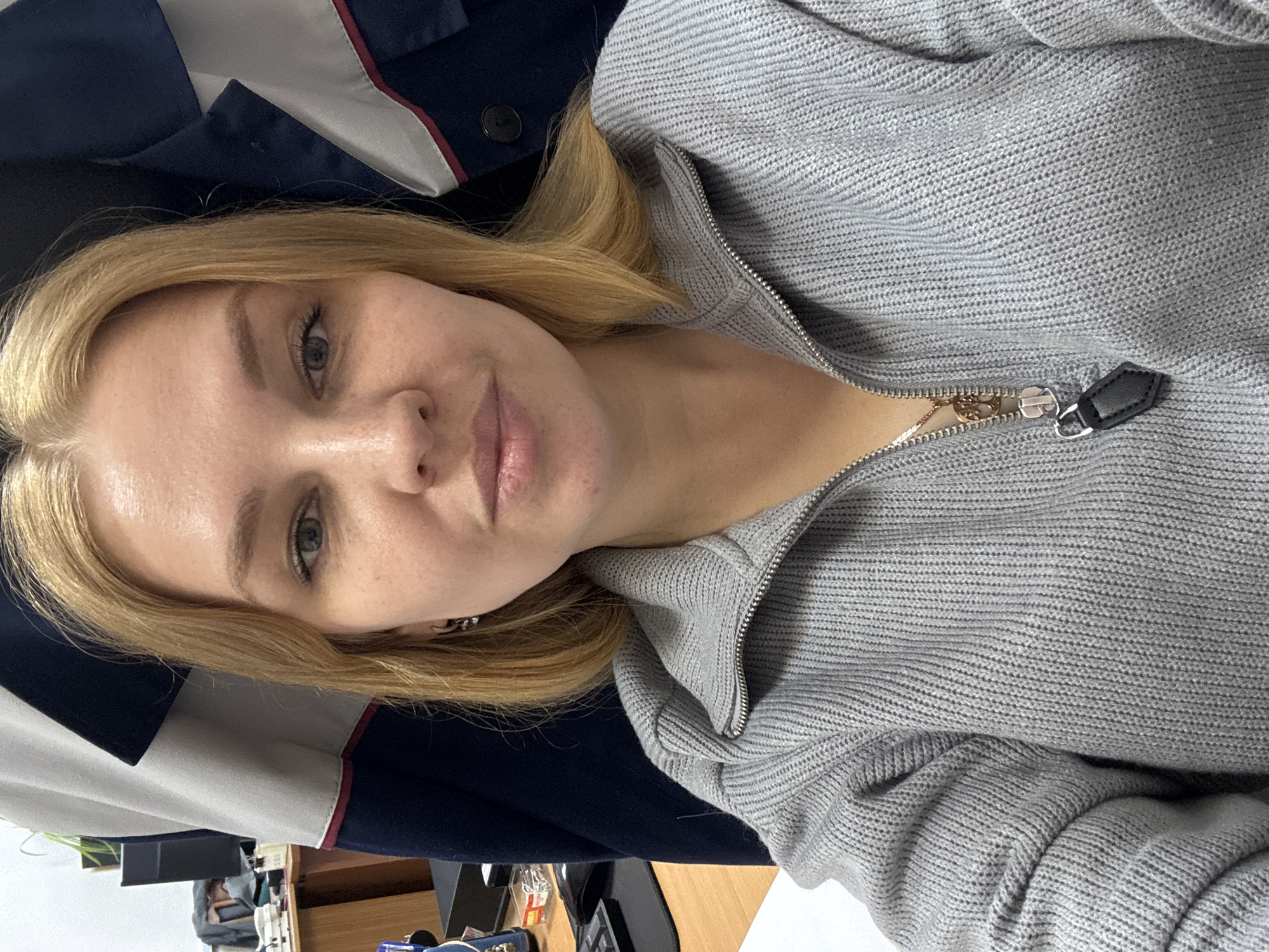 Woman takes selfie in gray sweater in Rusanovo