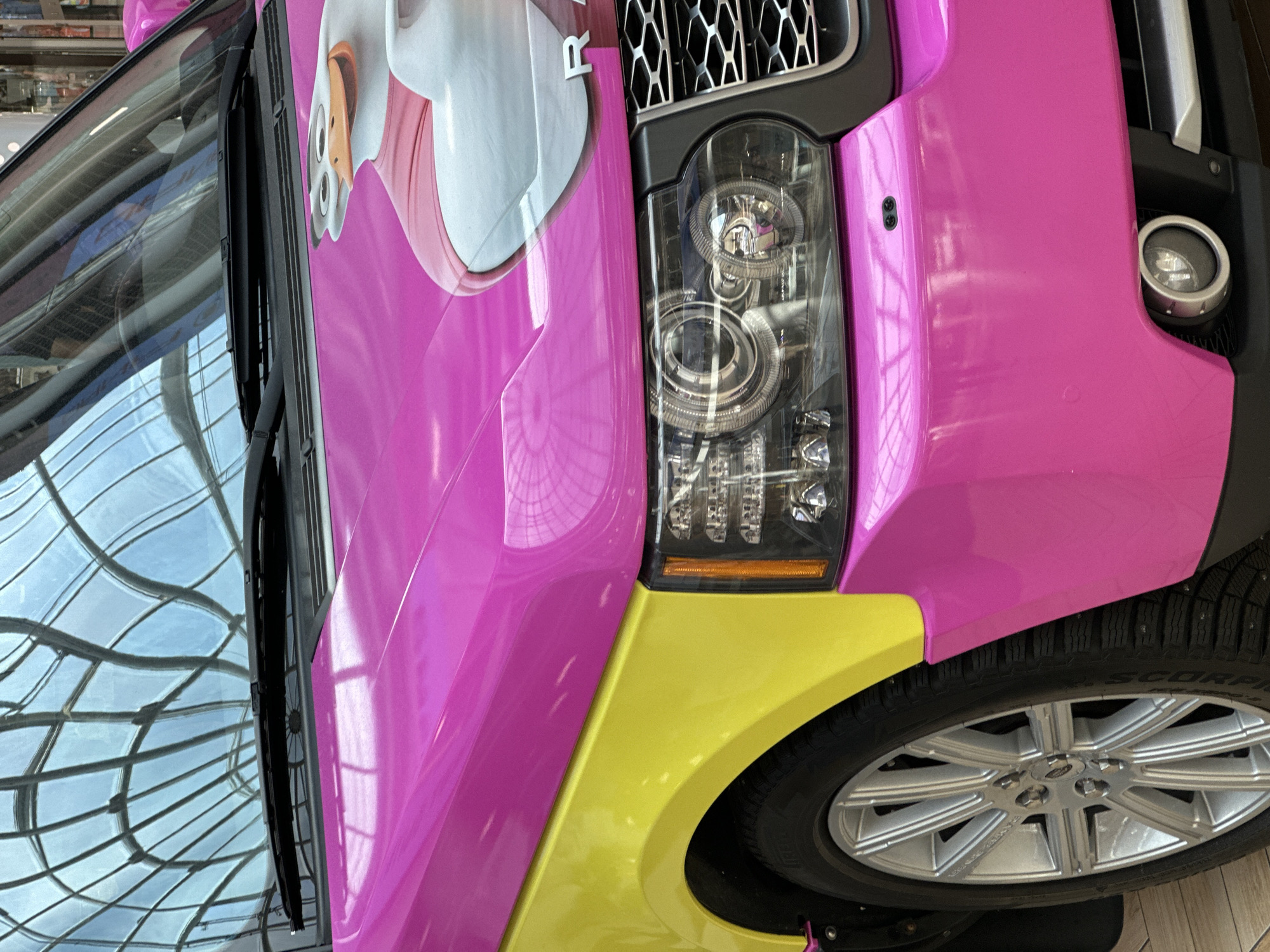 Pink Range Rover with duck graphics displayed in Minsk mall