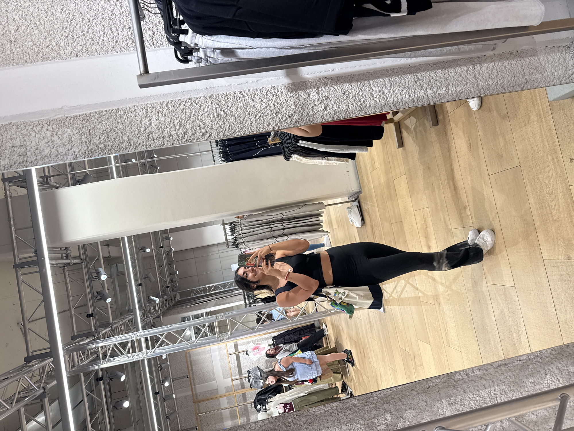 Woman takes mirror selfie while shopping in Puebla store