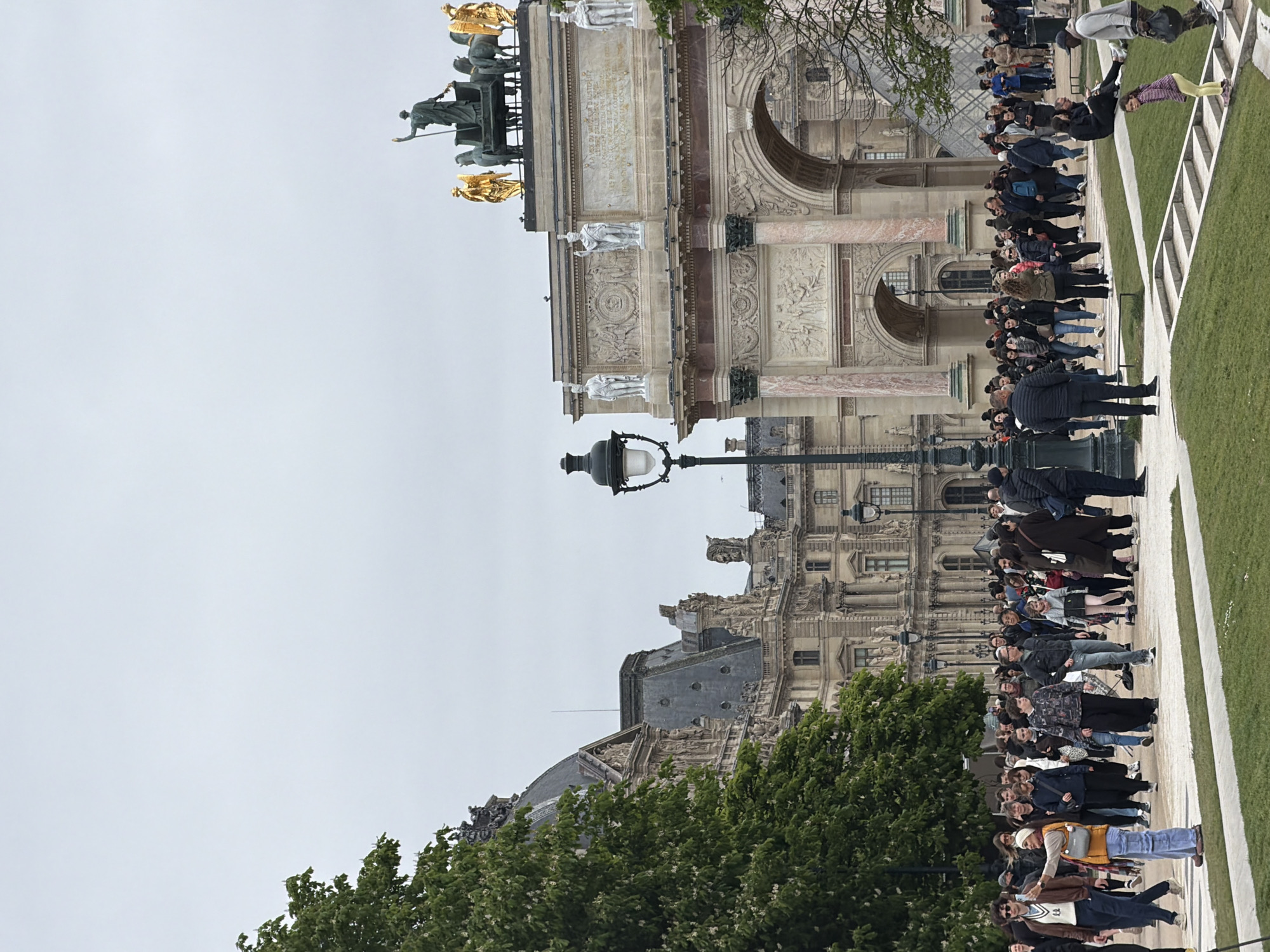 Gold knight statue observed amid tourist queues in Paris