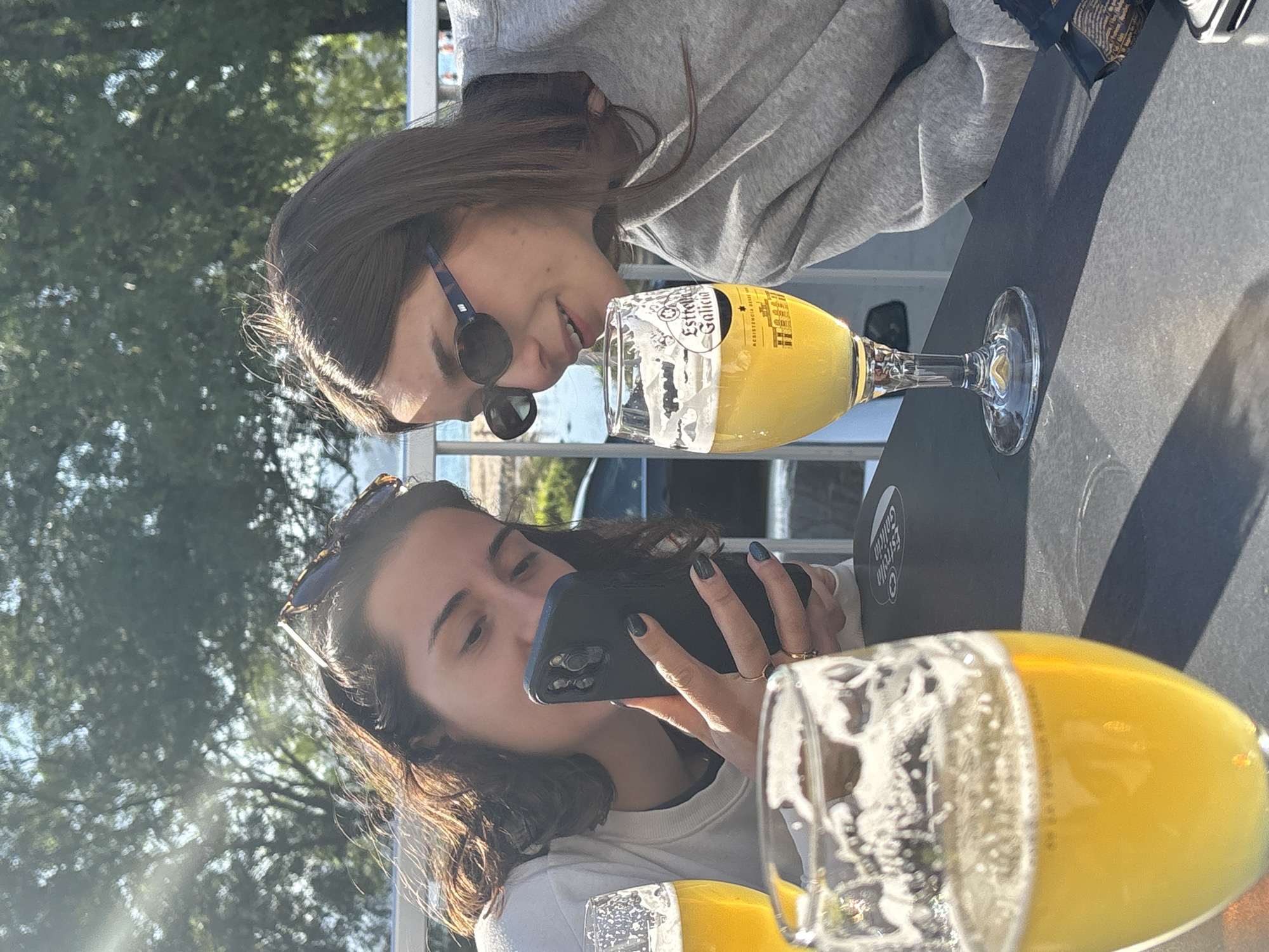Women relax with dog on patio in O Porto do Son