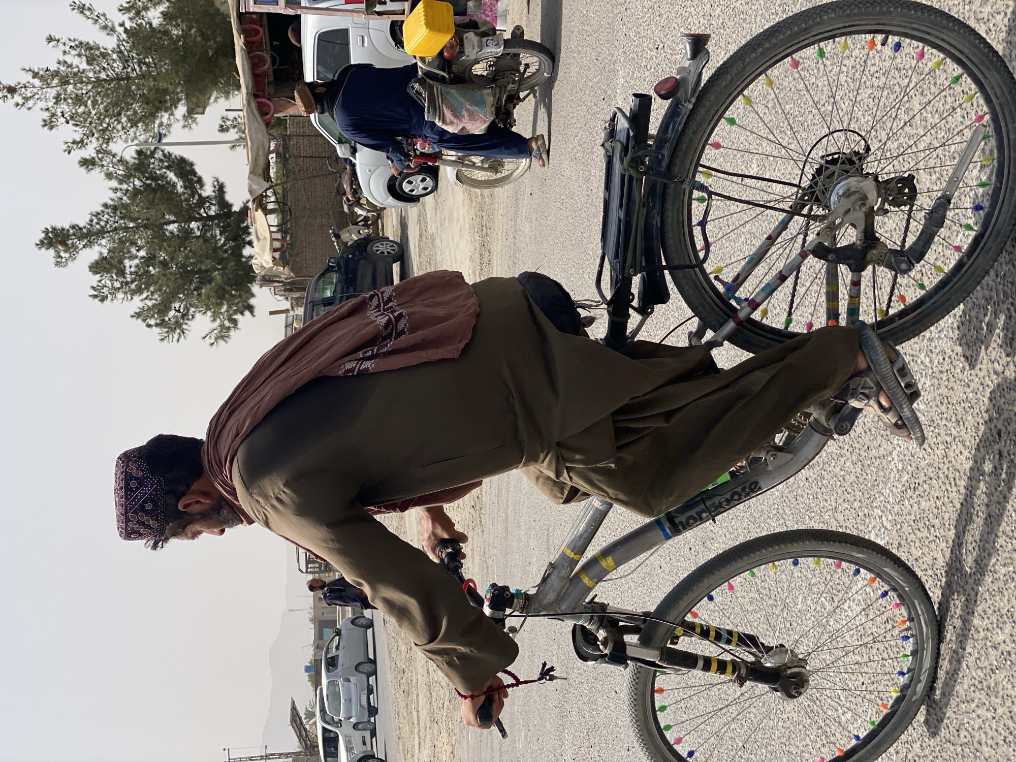 Kandahar street life: vendors, cyclists, and utility vehicles