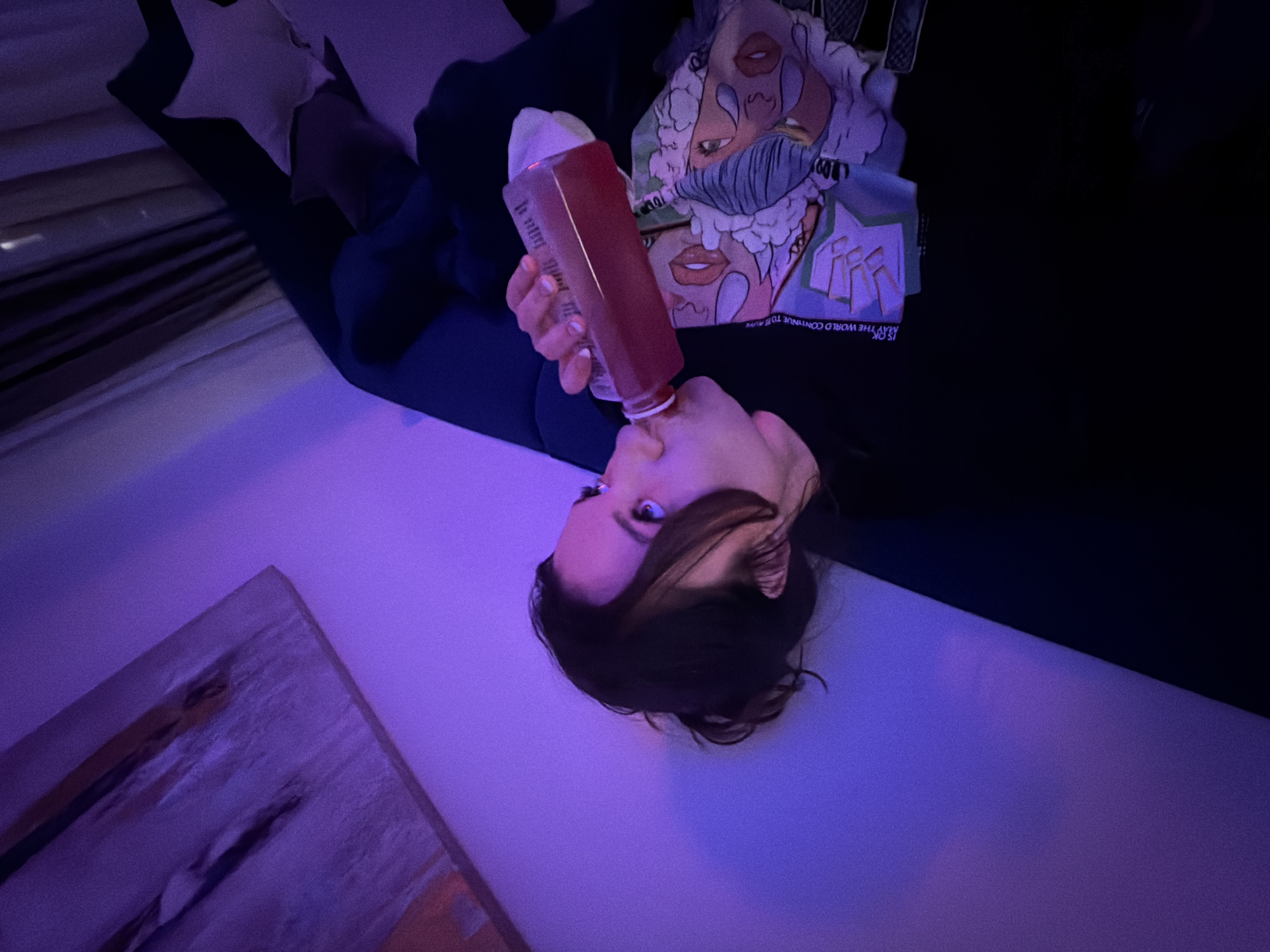 Woman relaxes with drink on sofa in Belgrade evening
