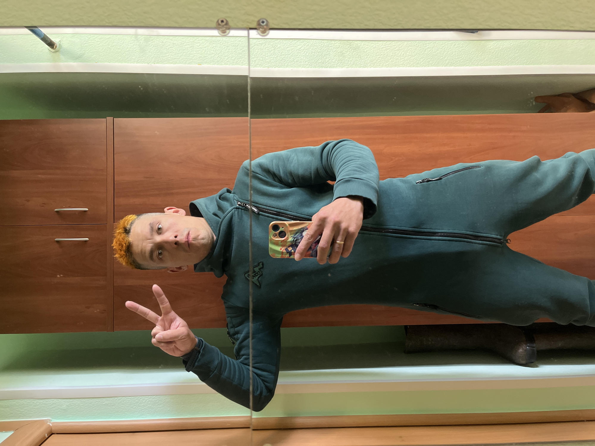 Man takes mirror selfie in jumpsuit in Chaikovsky