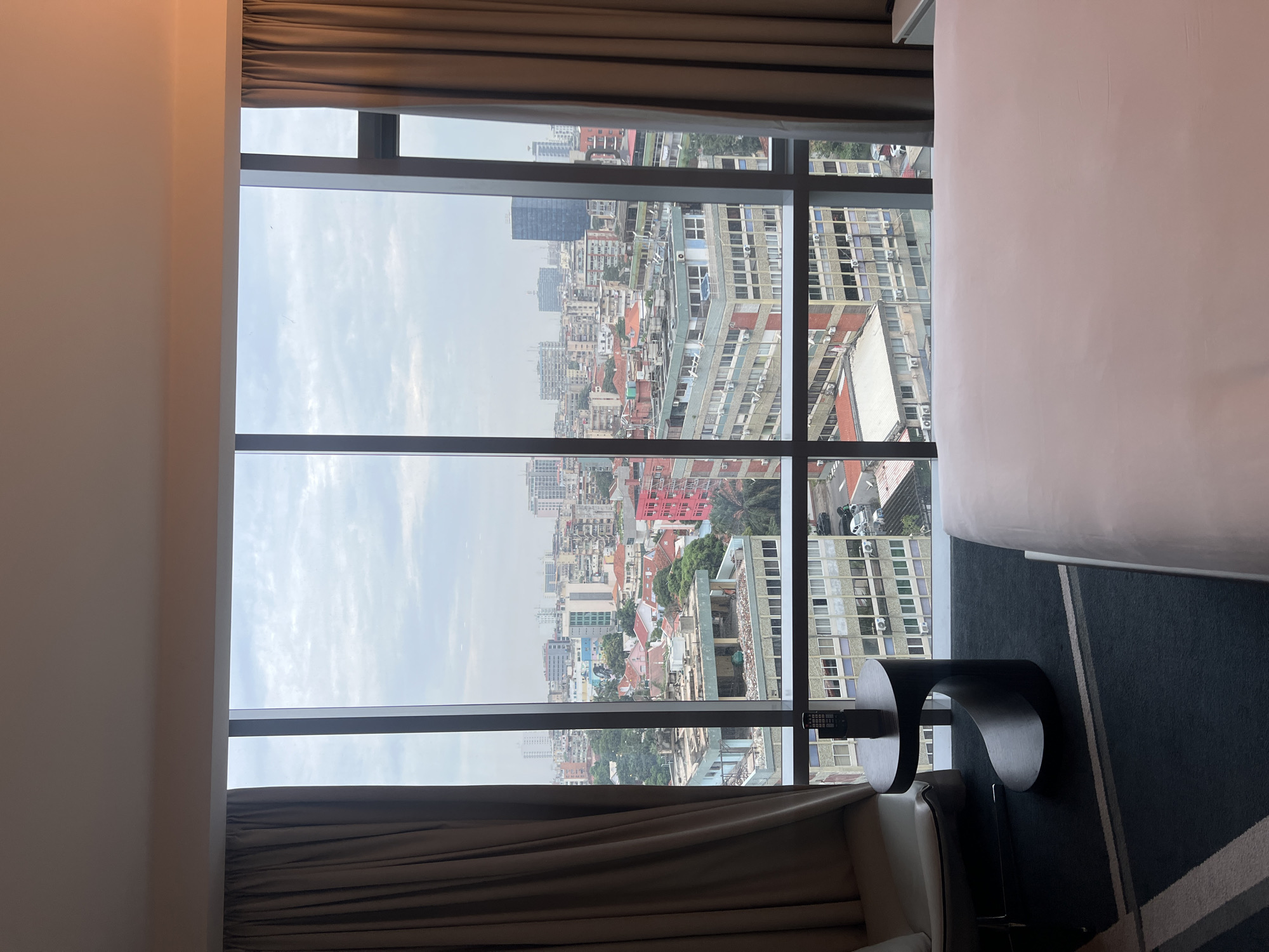 Observer documents overcast cityscape through window on May 14