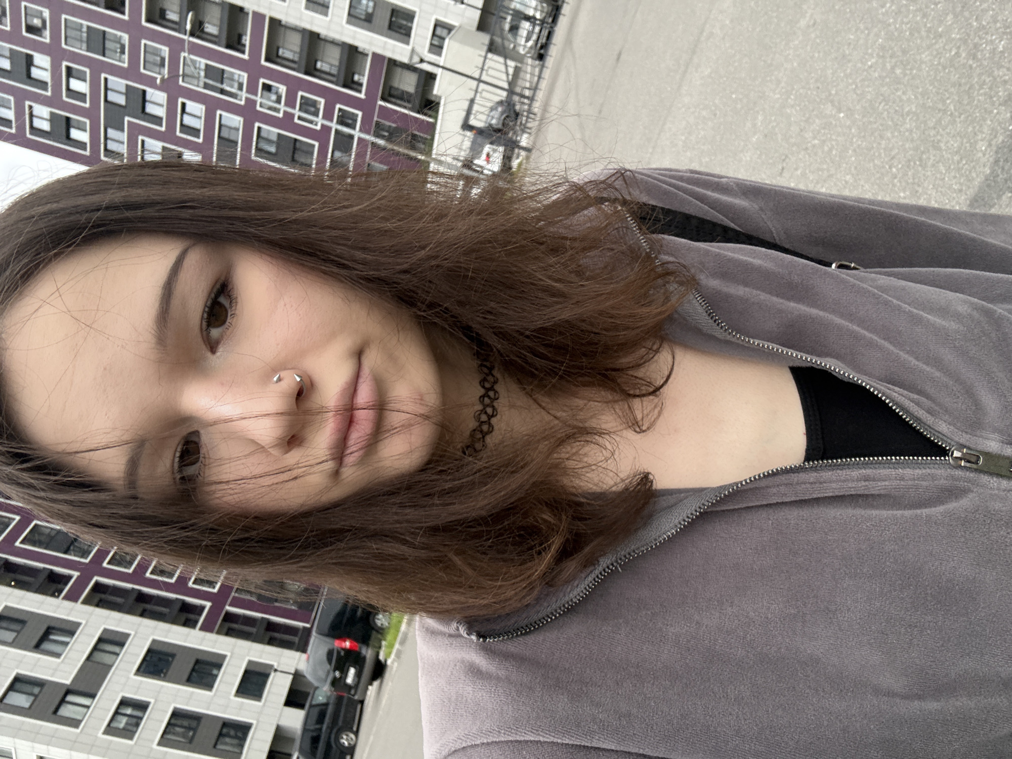 Woman takes selfies outside apartment building in Kokkorevo