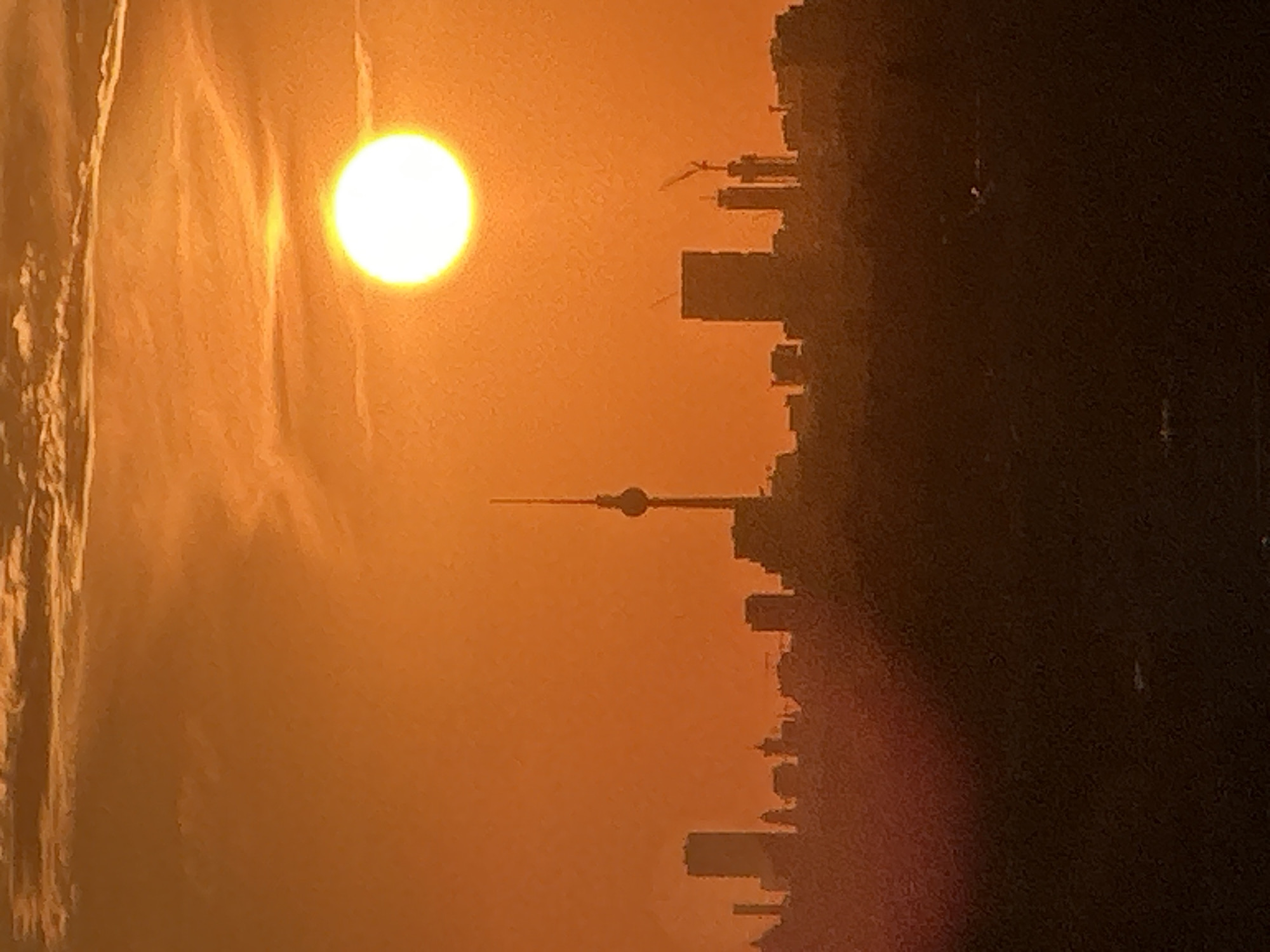 Berlin skyline glows under a warm July sunset