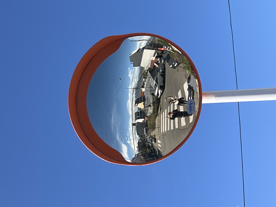 Traffic mirror captures everyday street crossing in Ushuaia