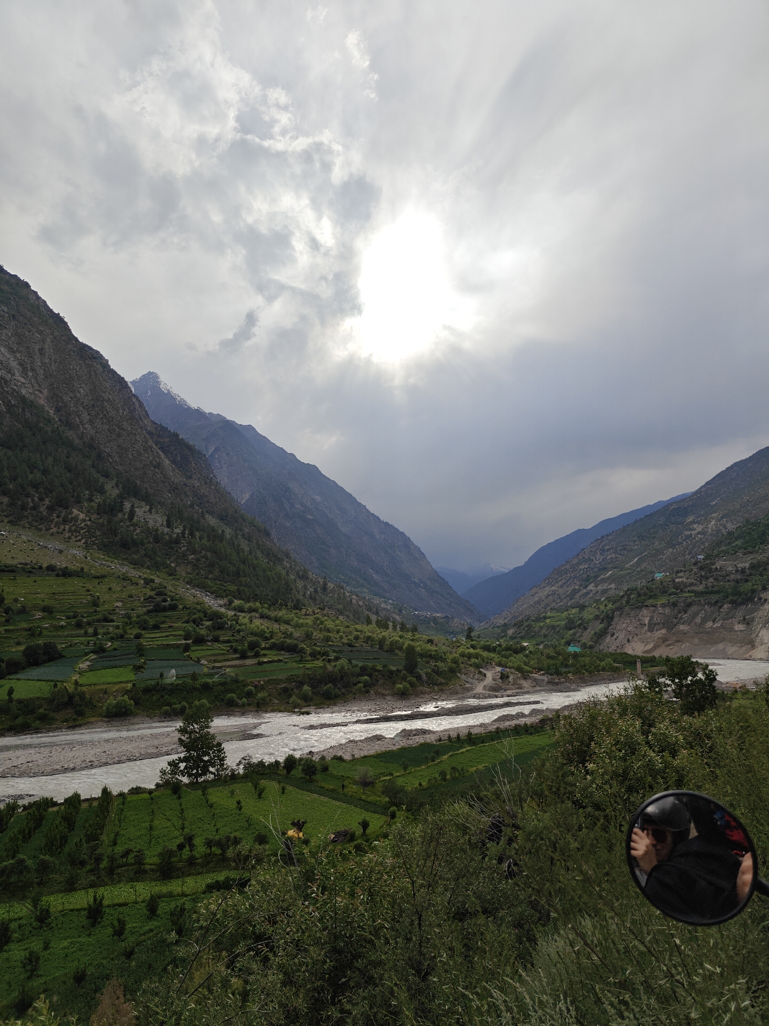 Dramatic mountain valley and terraced fields under stormy skies, Jahlmah