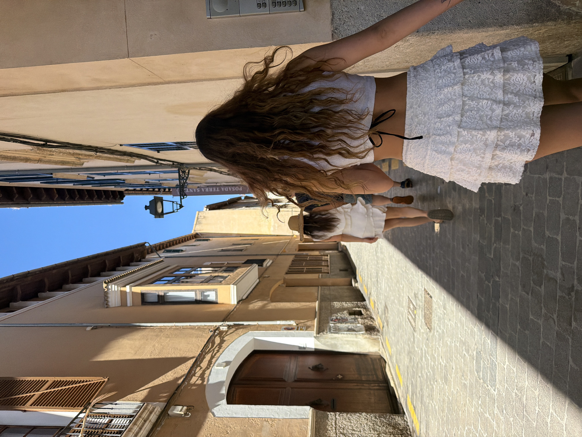 Women stroll cobblestone streets of historic Palma de Mallorca