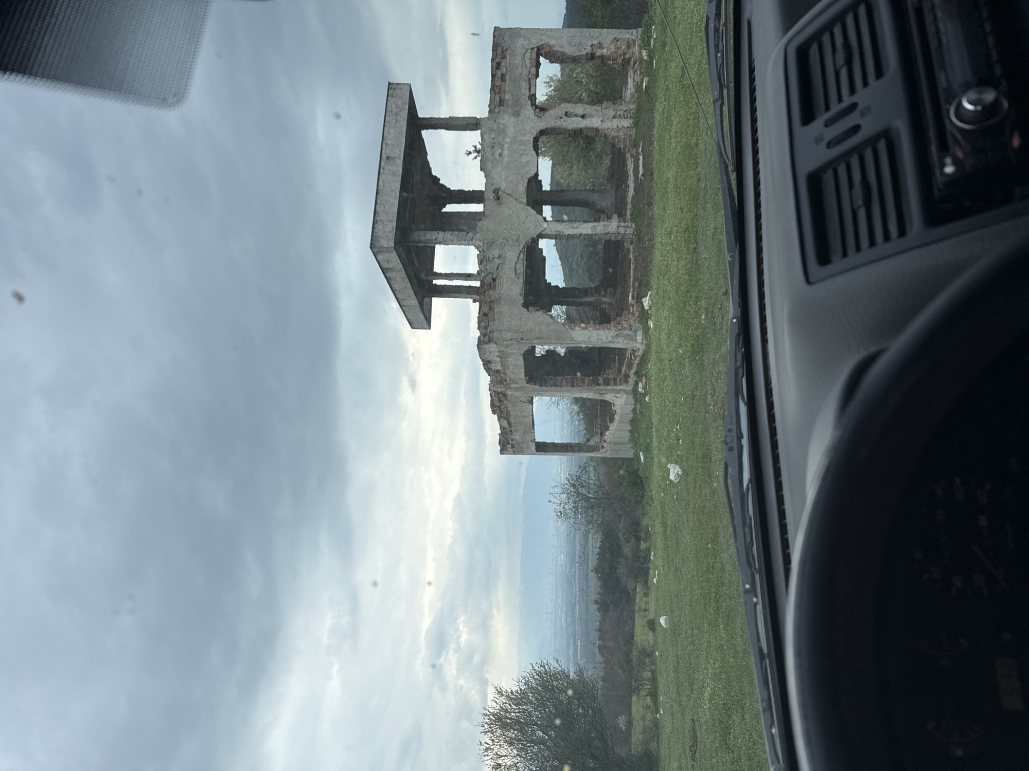 Abandoned buildings and parked SUV observed in rural Bulgaria