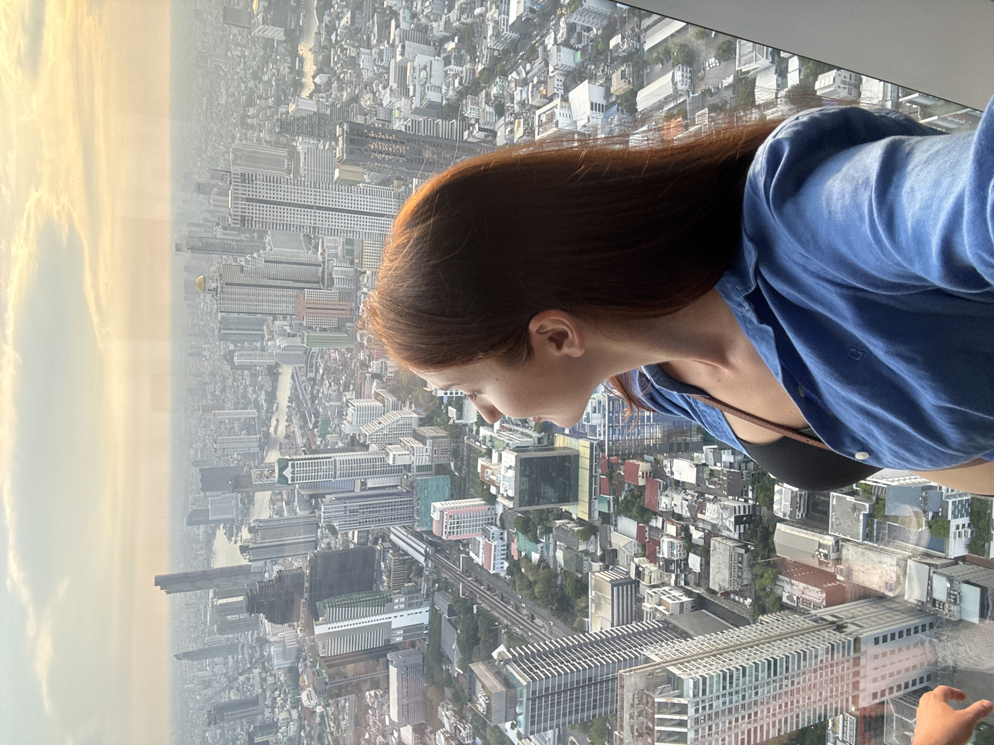 Tourists observe Bangkok skyline from high-rise observation deck