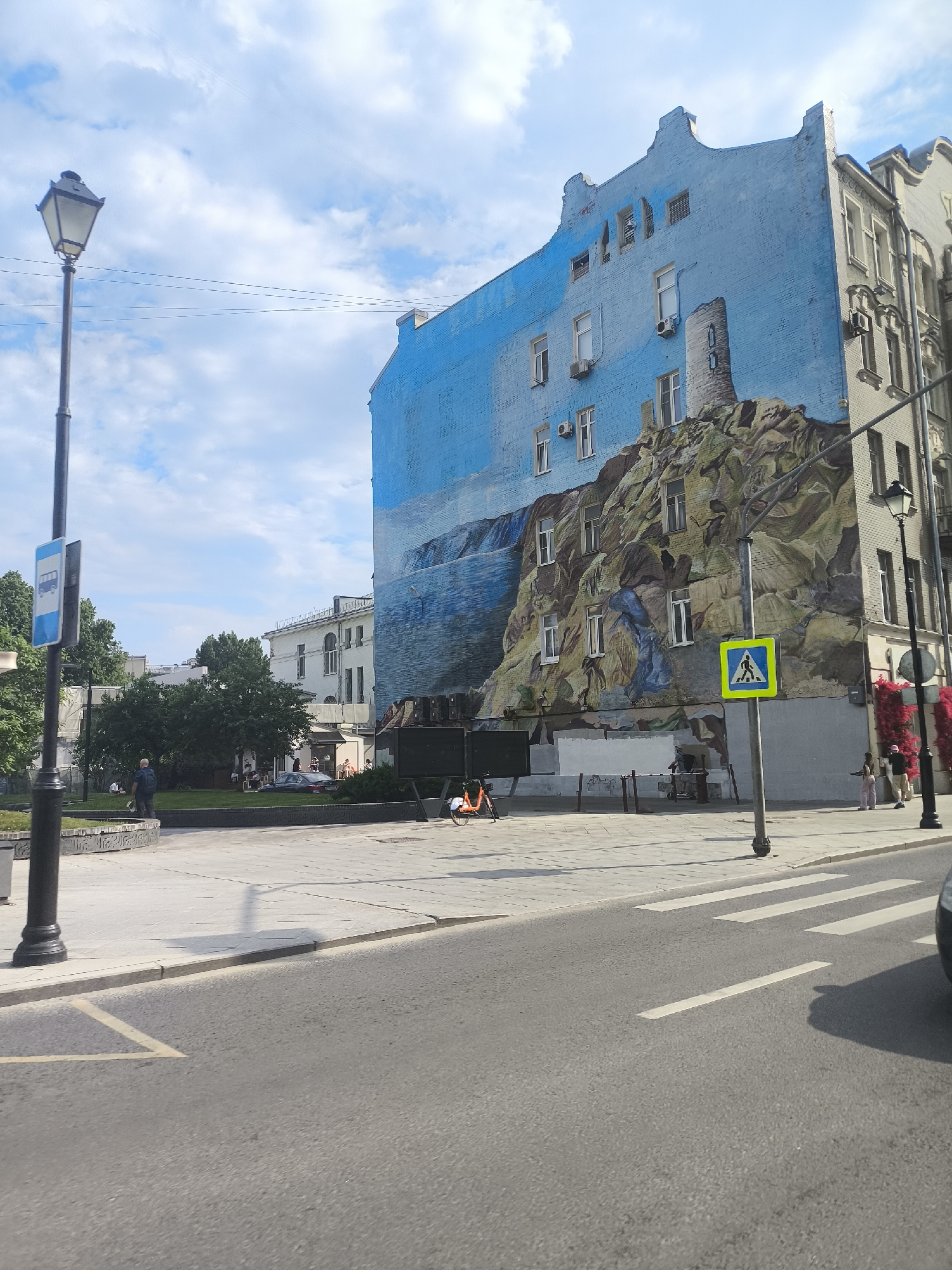 Moscow street scenes captured showing mural, restaurant, Orthodox church