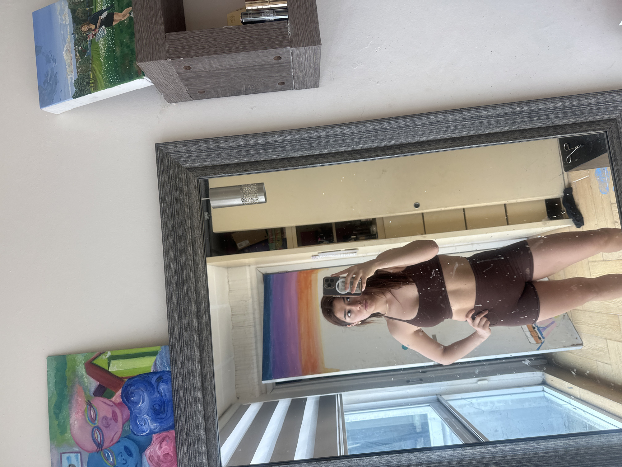 Person takes mirror selfie in athletic wear in Puebla