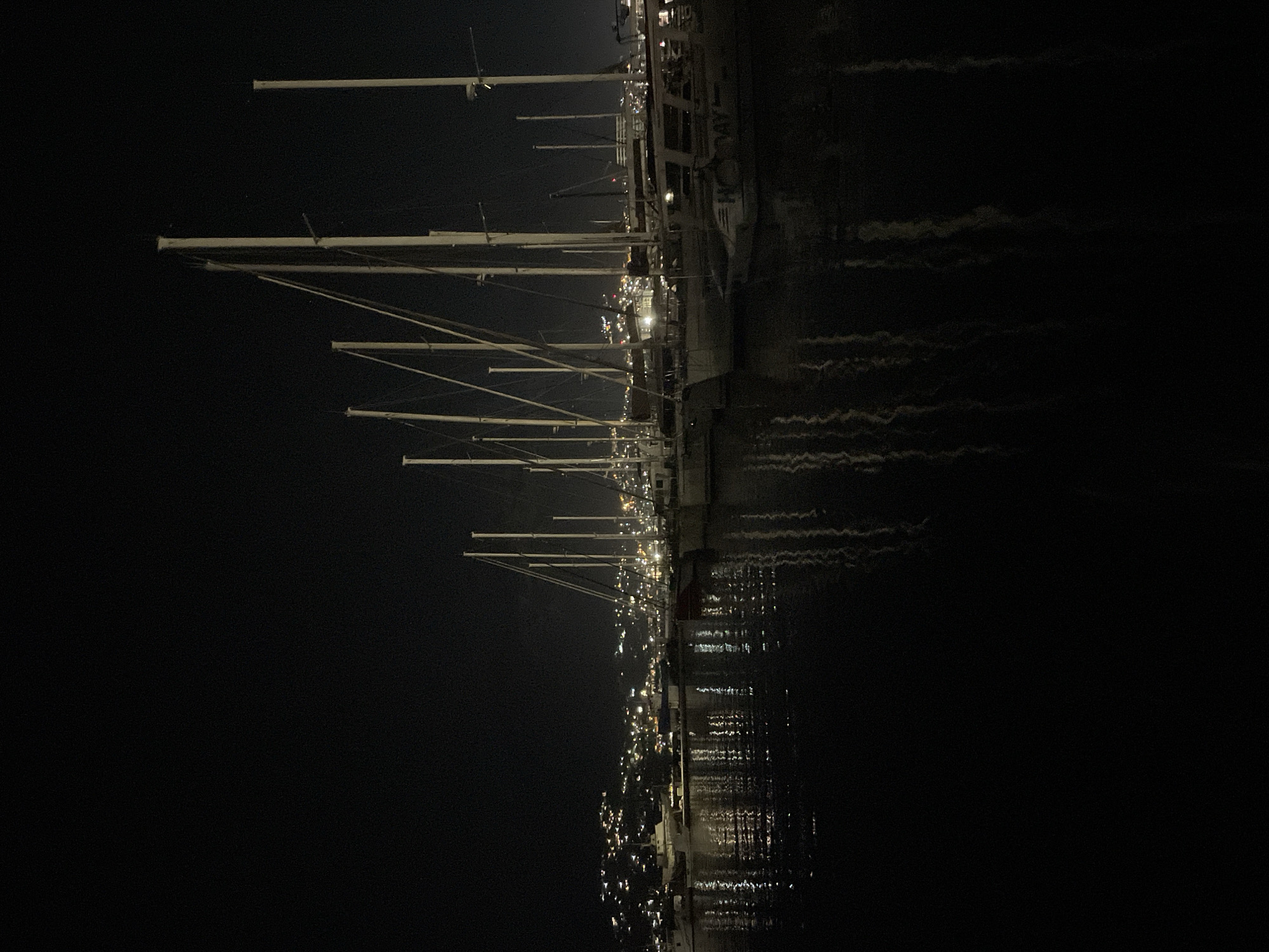 Purple-lit superyacht docked at Bar Marina after dark