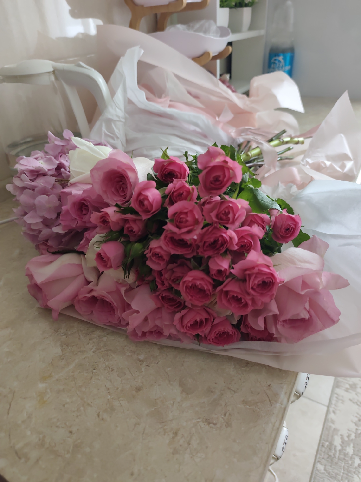 Pink and white roses arranged at a home in Astana