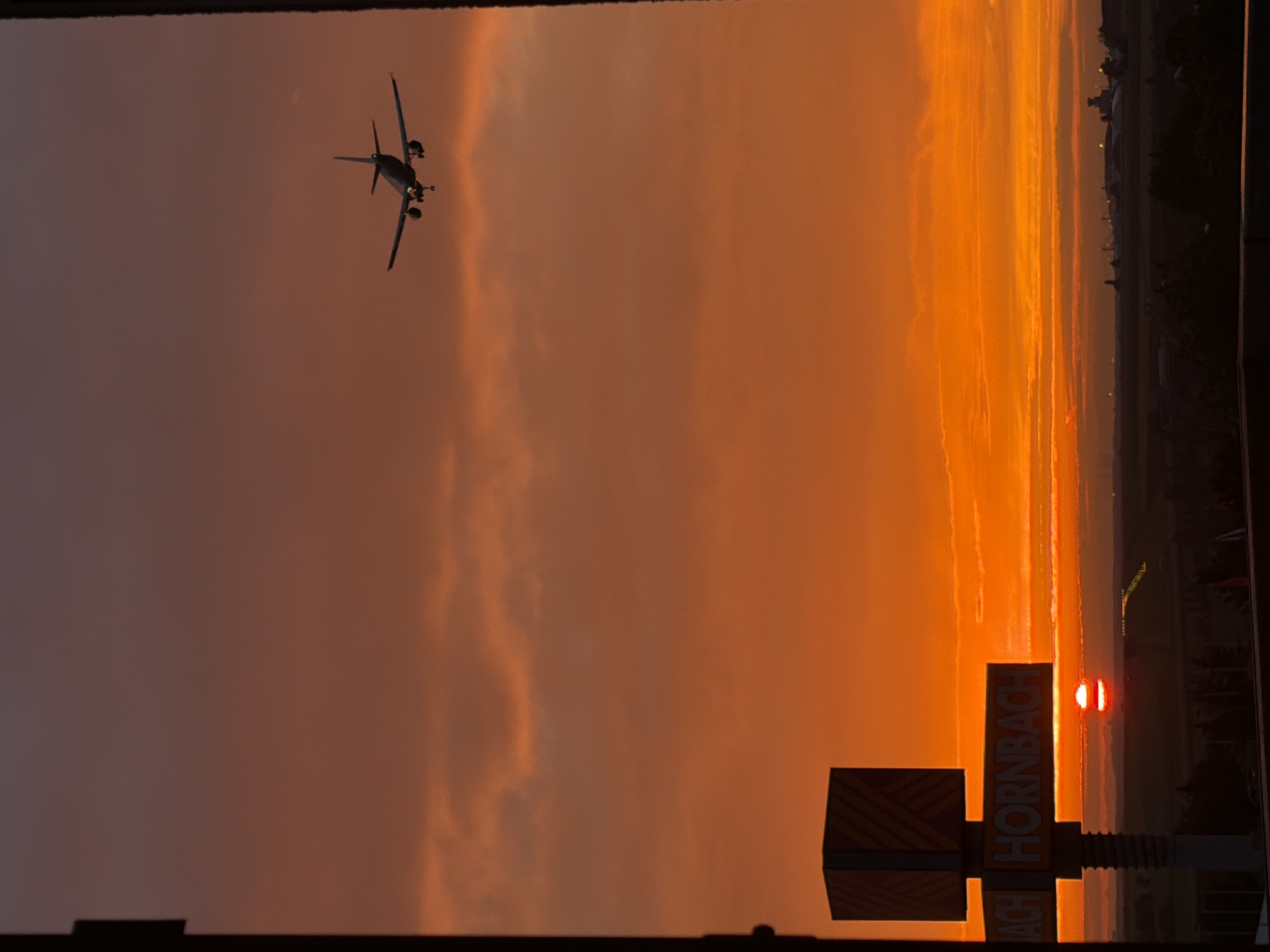 Prague sunset with airplane, shot through window and open sky