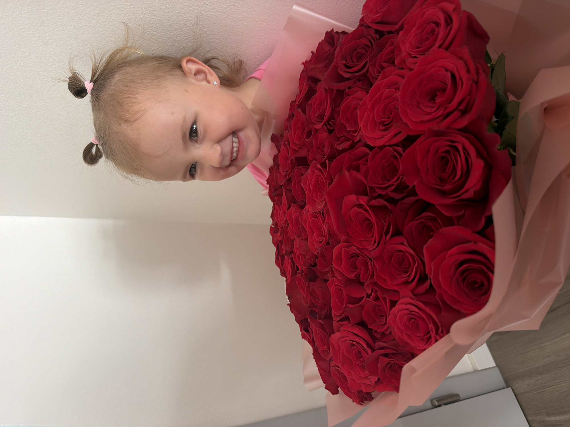 Cheerful indoor moment in Prague featuring a bouquet of red roses