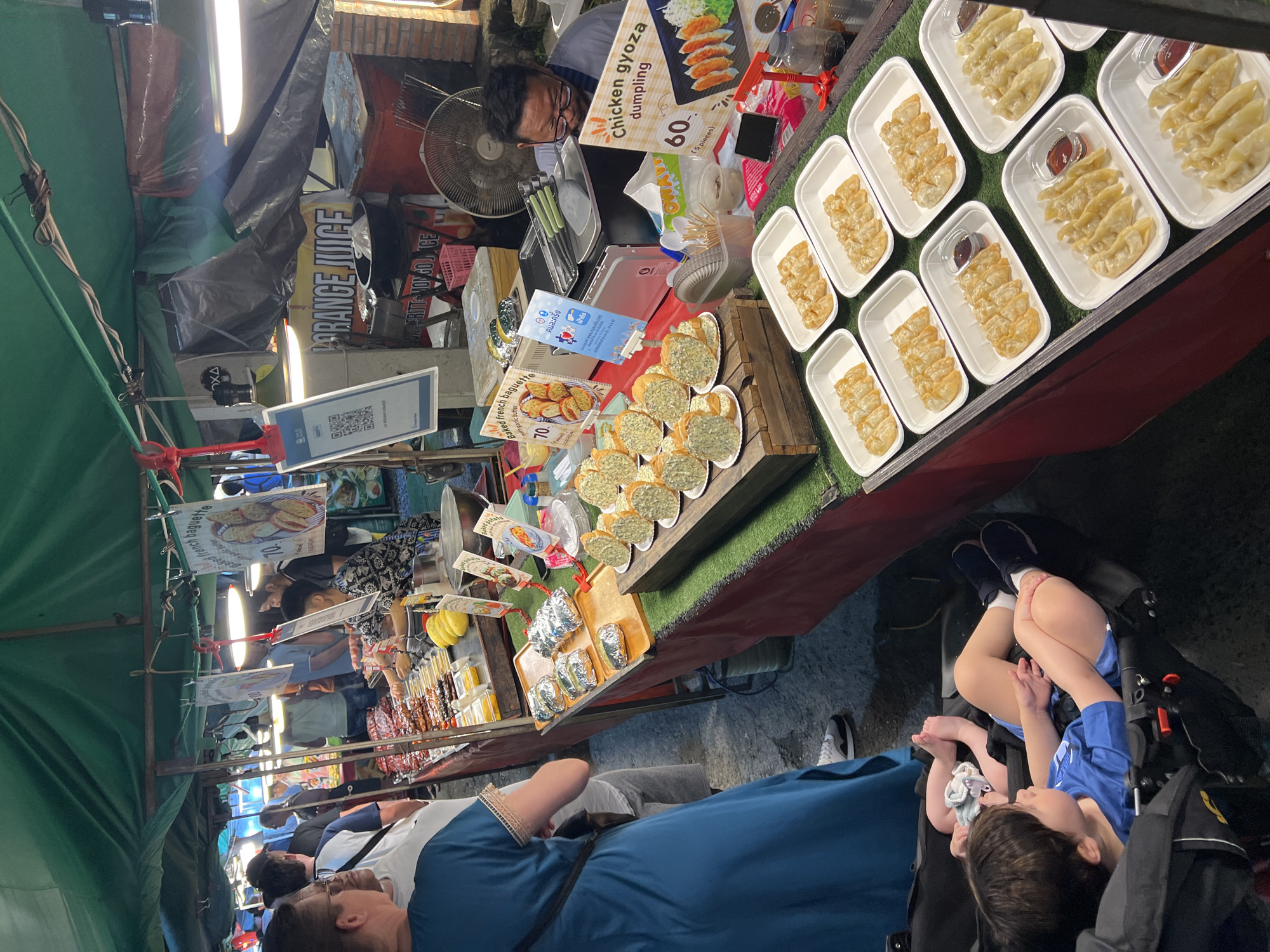 Night market food vendors and vehicles documented in Thailand