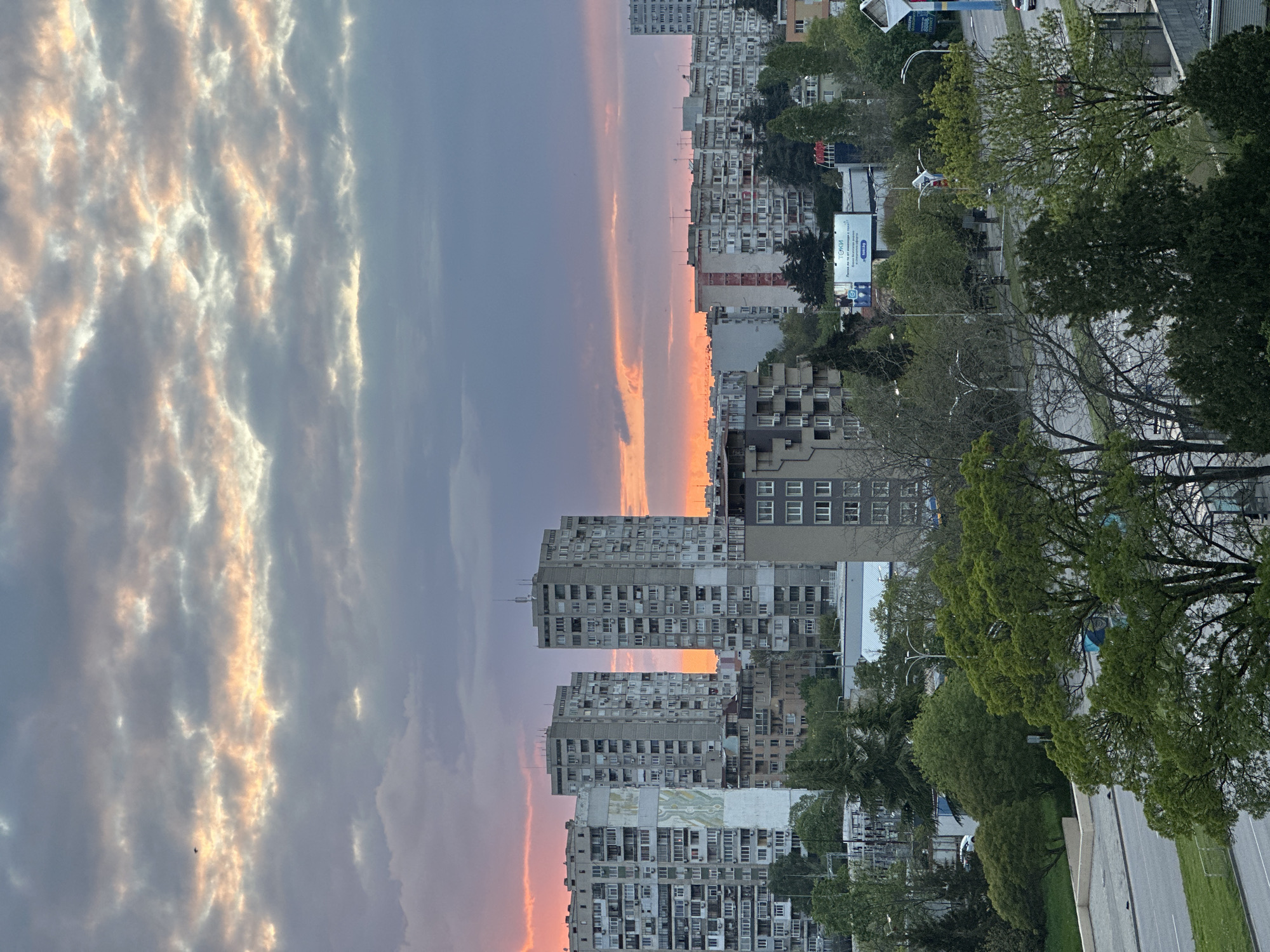 Urban sunset photography session captures dramatic sky, residential buildings