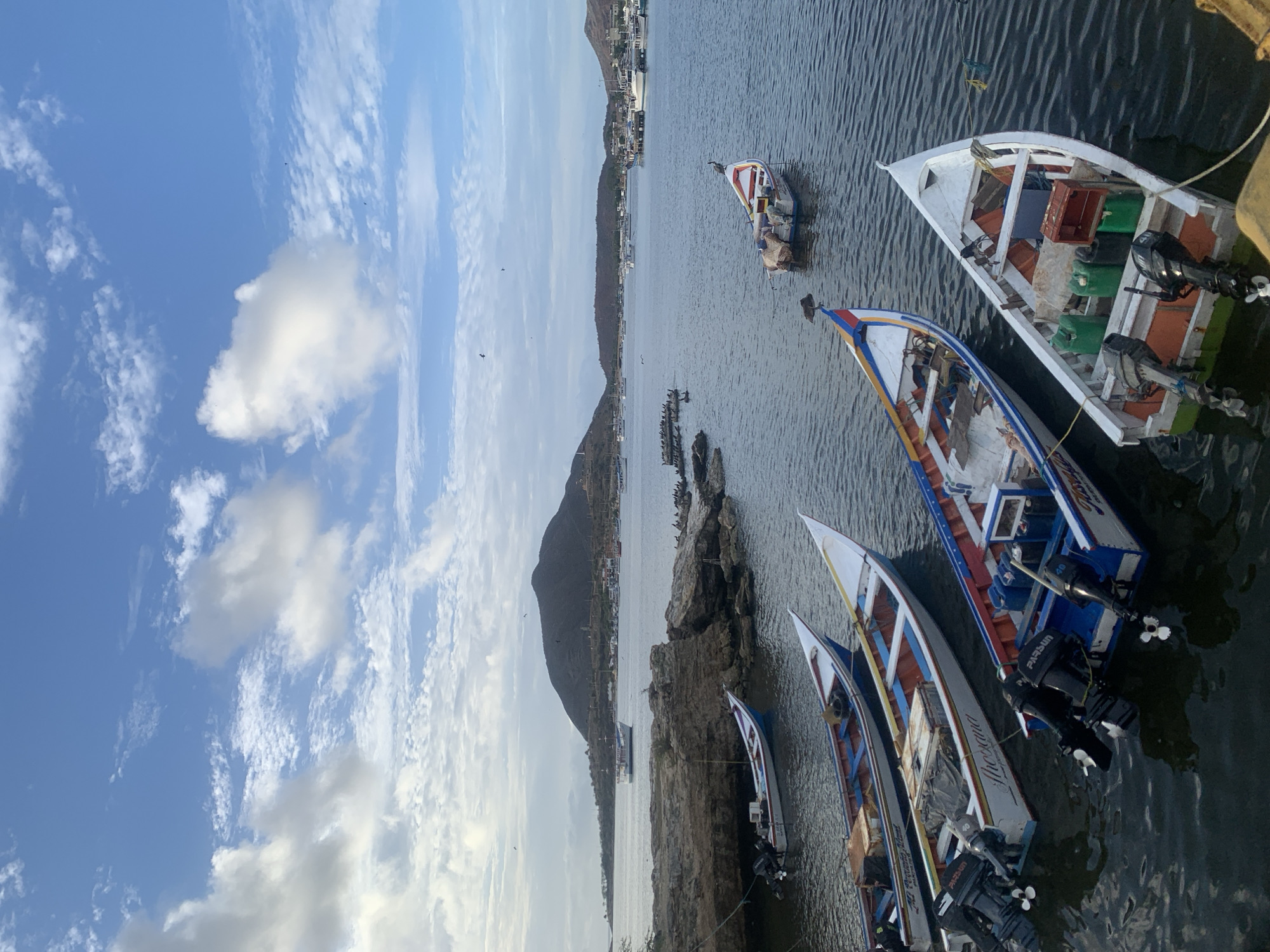Quiet afternoon at Juan Griego's harbor, boats and paddleboarders