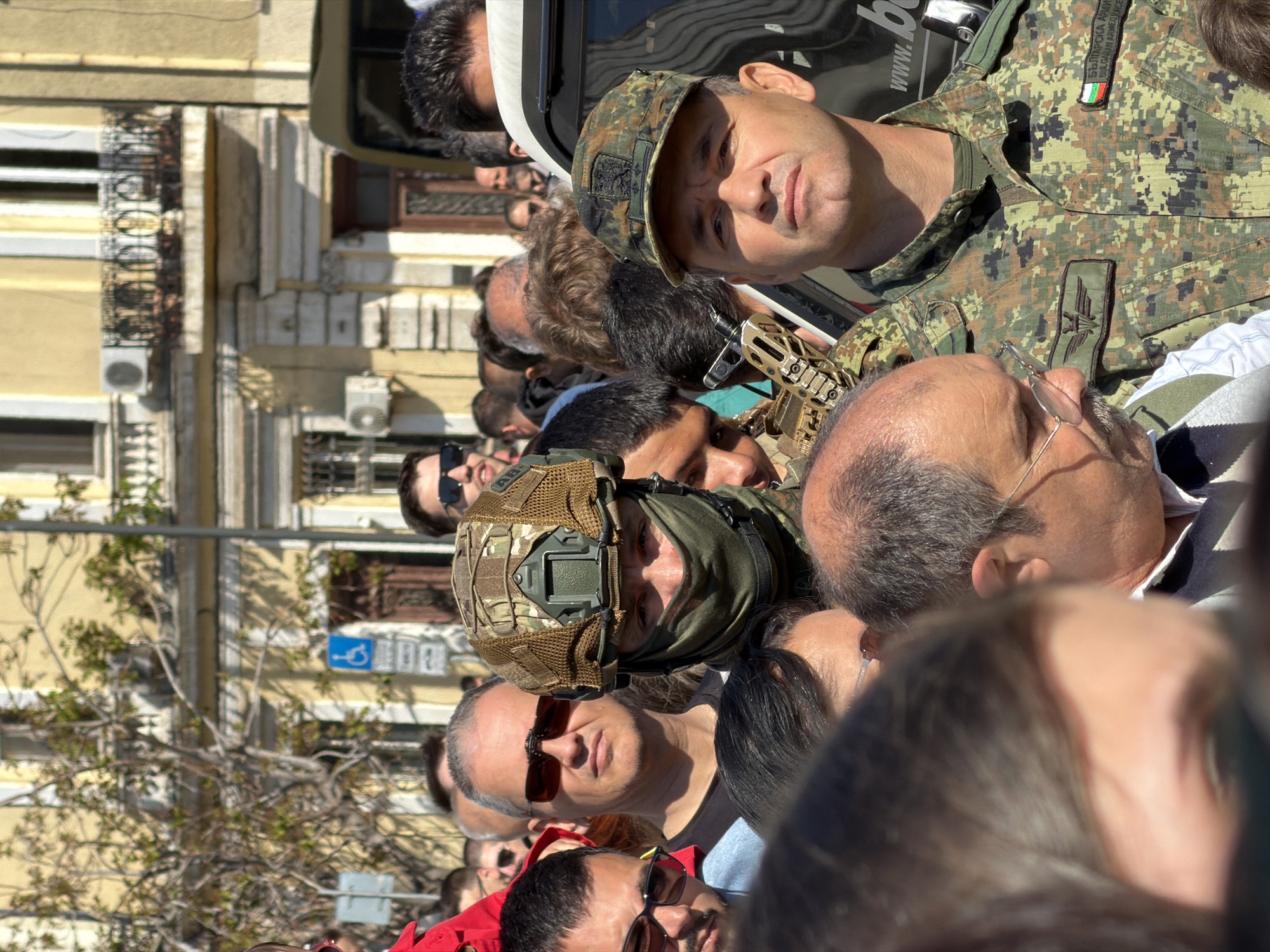 Crowd gathers in Sofia with military presence, Bulgarian flag visible