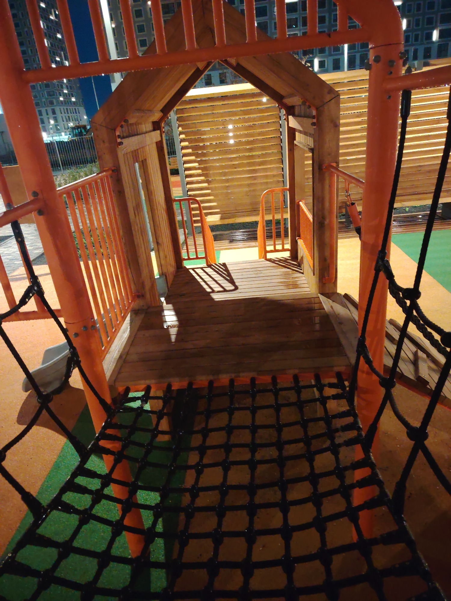 Nighttime playground and courtyard at a residential building